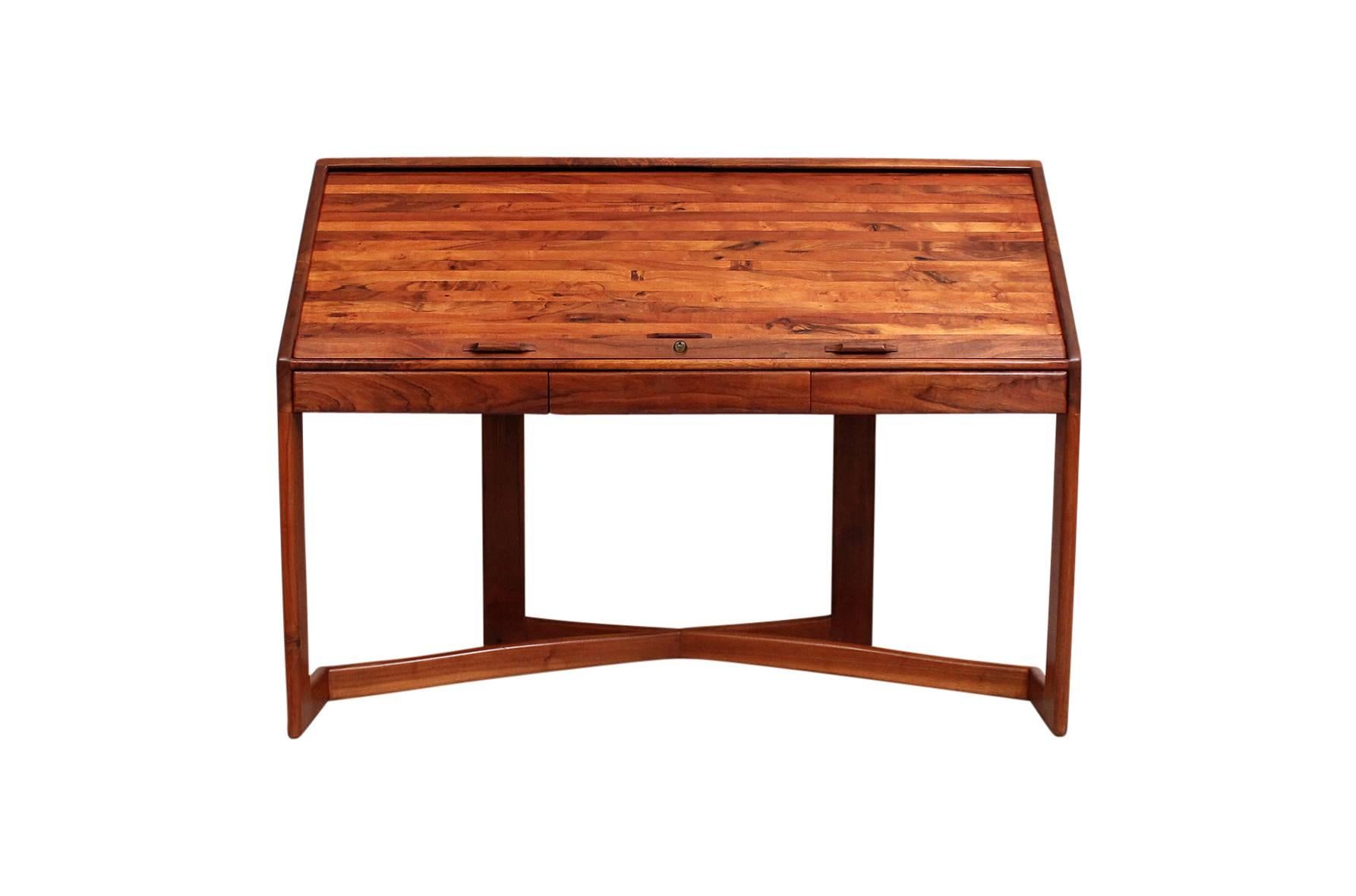 Walnut studio furniture roll top desk by husband and wife Robert and Joanne Herzog. Custom designed and built in California circa the 1970s. Interior of the roll top desk features numerous cubbies and drawers along with a large work surface. There