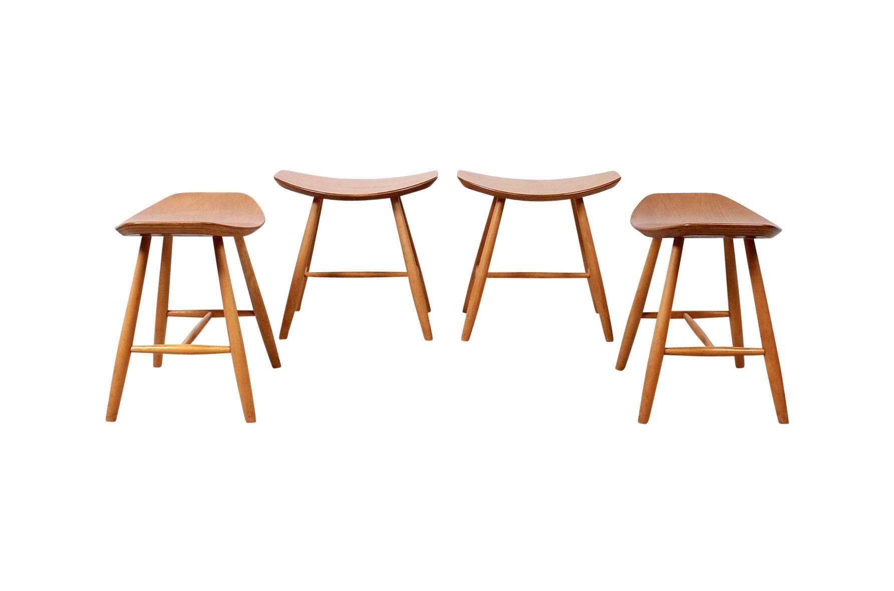 Set of four birch stools by Ejvind Johansson and produced by FDB Mobler, Denmark. These are considered Model J63. Attractive and comfortable design. Pair price available upon request.
