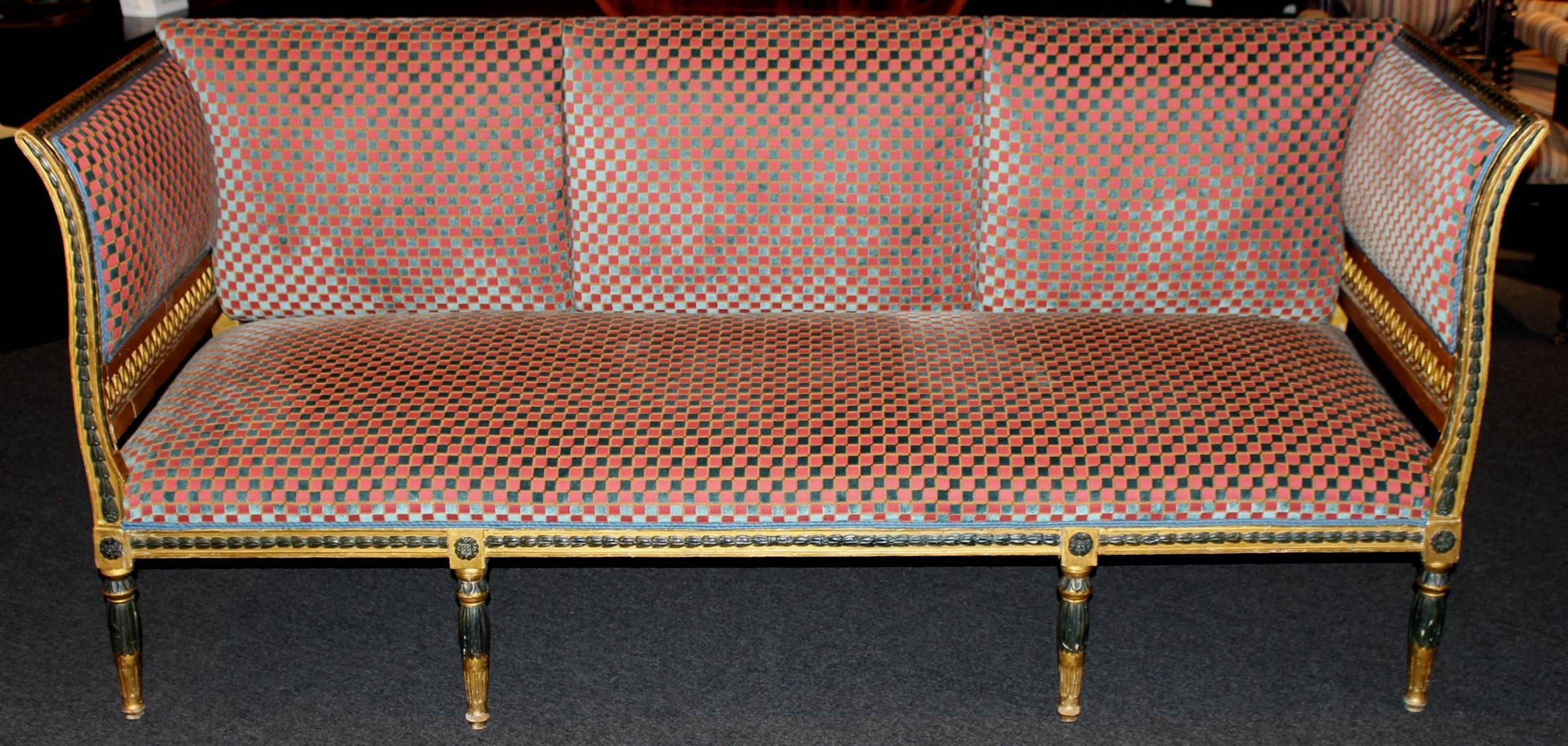 A Gustavian period neoclassical giltwood and polychrome sofa with stiles and rails decorated with carved bellflowers and reticulated side panels. Rear back supports probably a later addition, circa 1800, Sweden.
