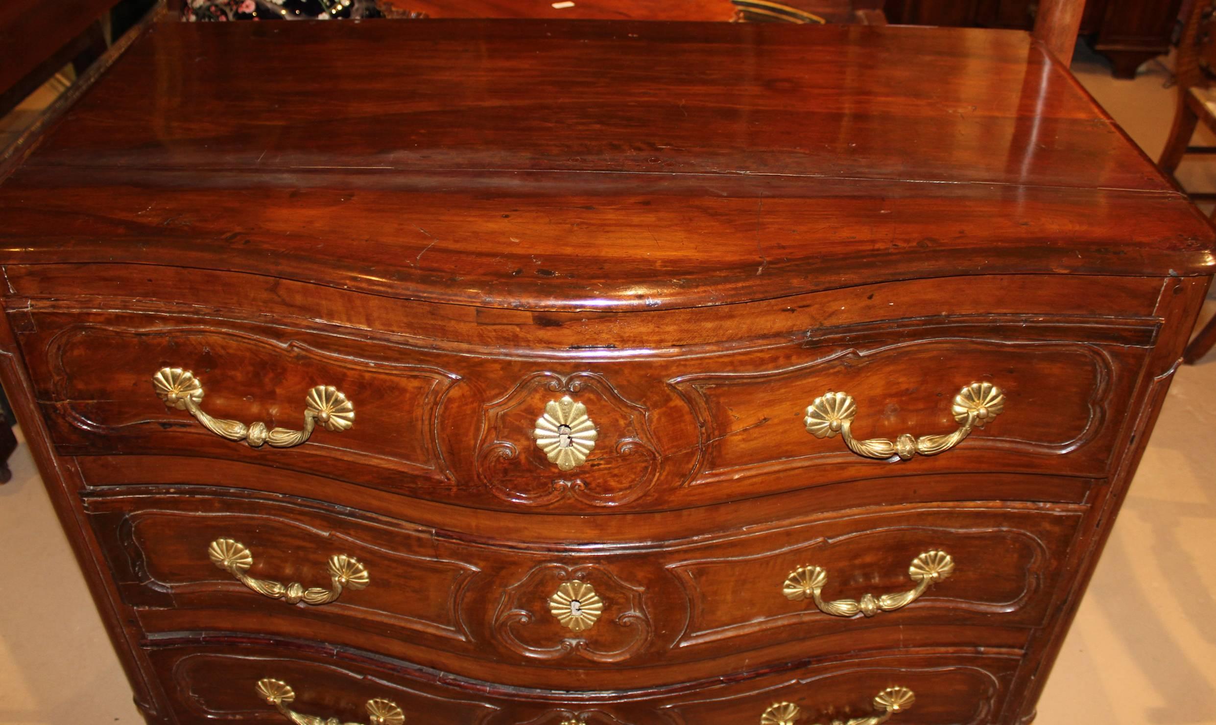 A fine 18th century French three-drawer fruitwood serpentine front commode with nice foliate carving and shaped skirt.