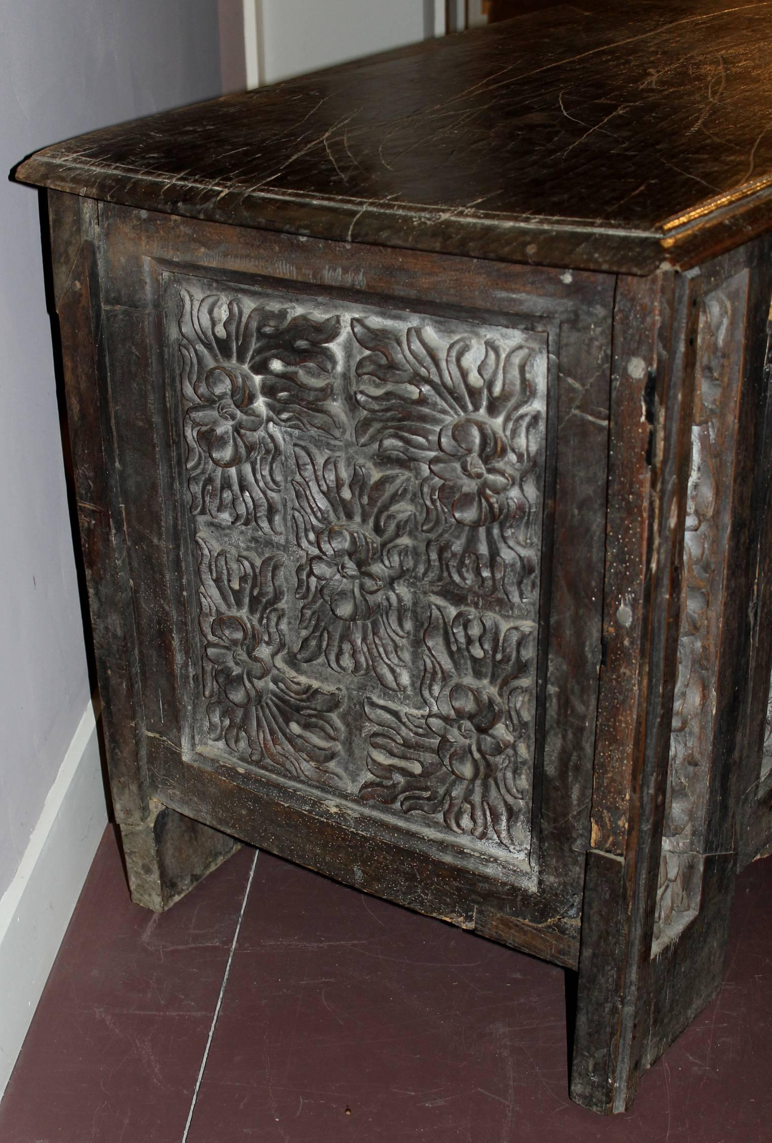An exceptional polychrome oak coffer with heavily carved foliate panels, dating to the17th century or earlier. Great overall patina and appears to have retained its original iron hinges and lock hardware. Some old repairs, shrinkage, edge losses,