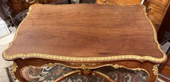 Early 20th Century French Walnut Center Table with Carved Giltwood Accents