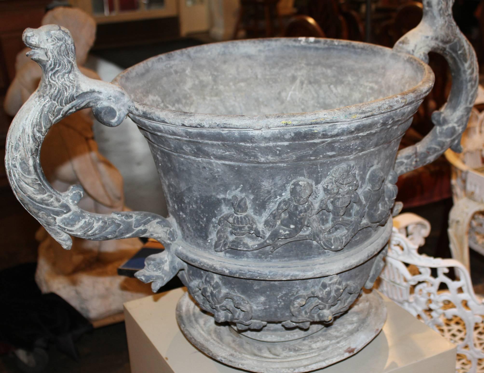 Italian Pair of Lead Urns with Figural Handles and Cherub Decoration