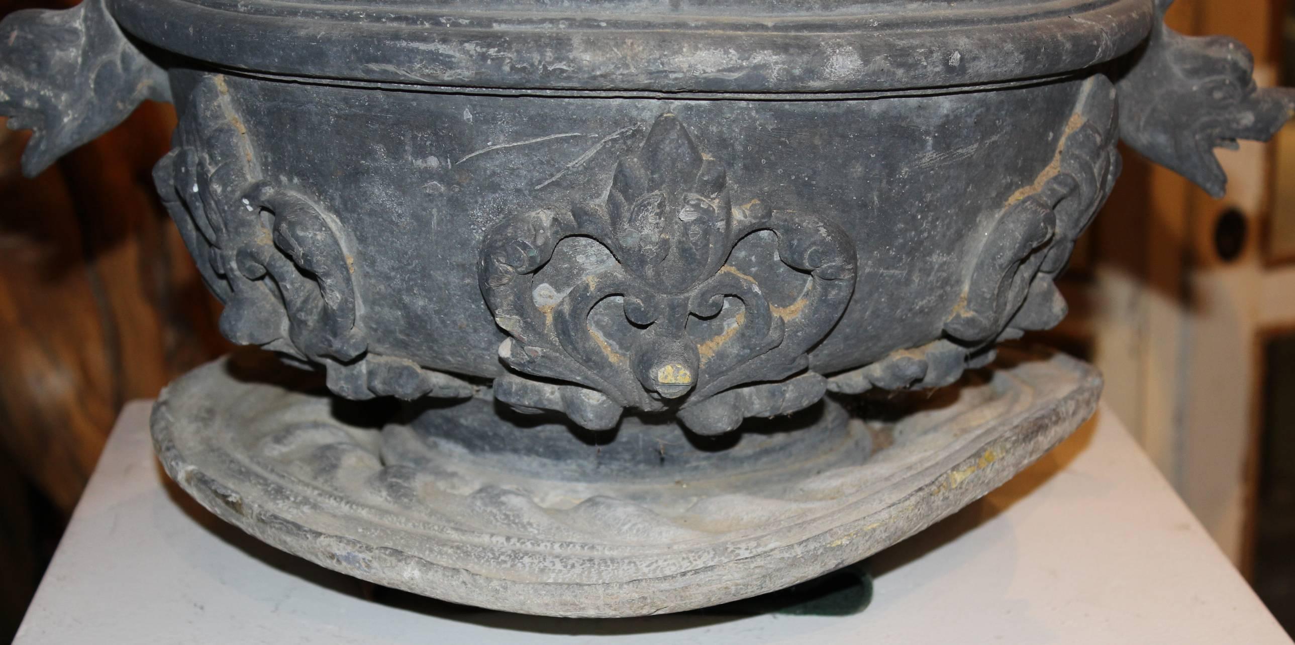 Pair of Lead Urns with Figural Handles and Cherub Decoration 1