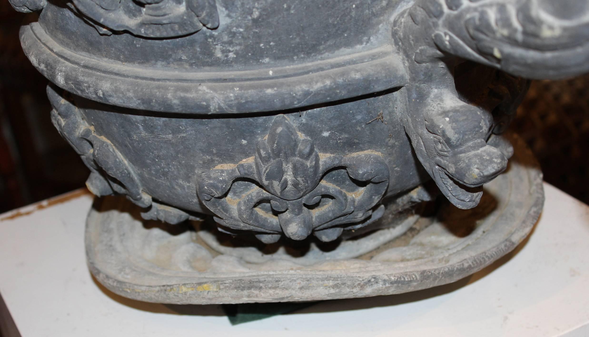 Pair of Lead Urns with Figural Handles and Cherub Decoration 3