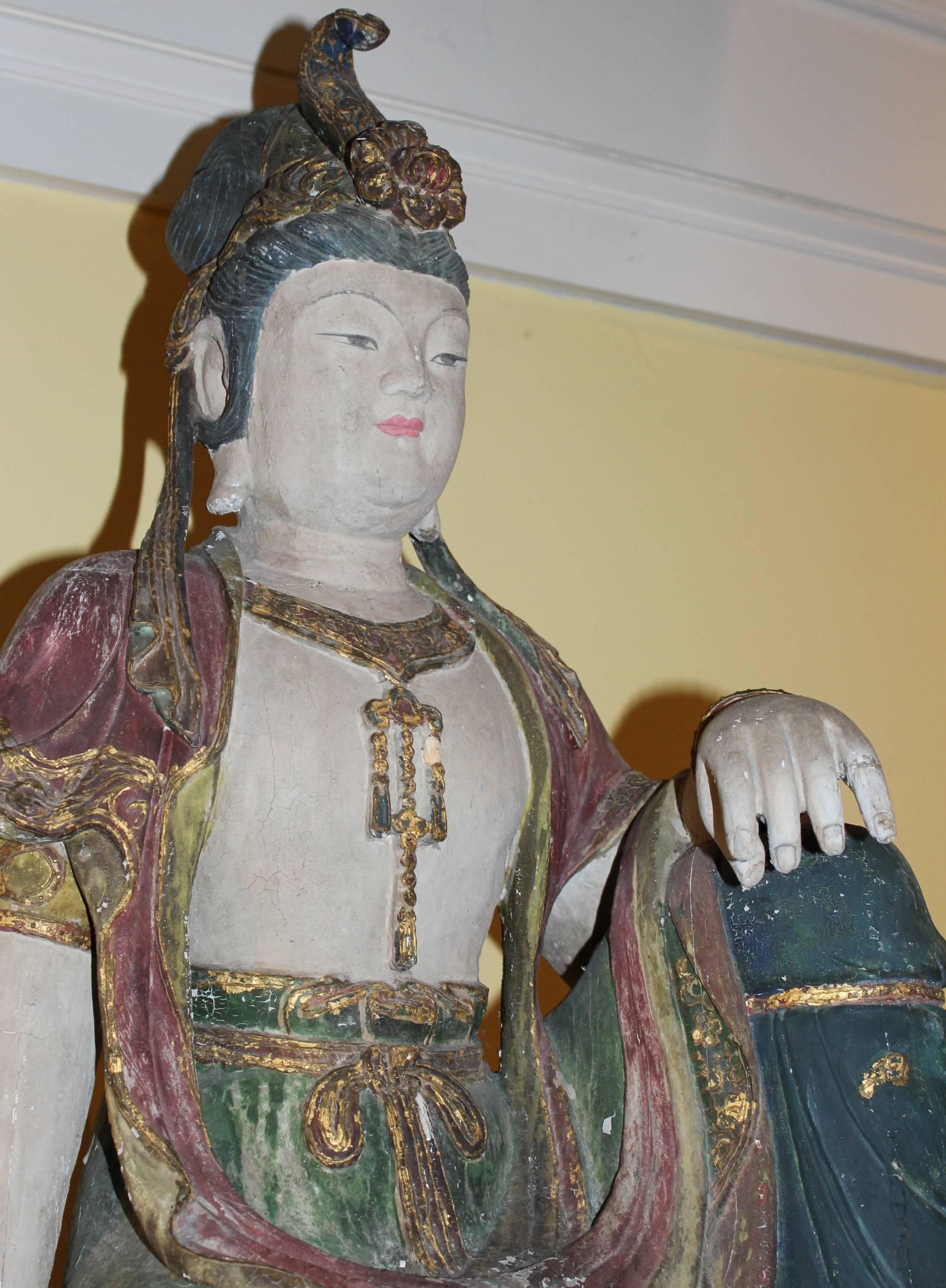 A fine example of a 19th century polychrome carved wooden painted seated figure of Guanyin, an East Asian bodhisattva associated with compassion by the Mahayana Buddhists, also commonly called the Goddess of Mercy, although depicted both as female