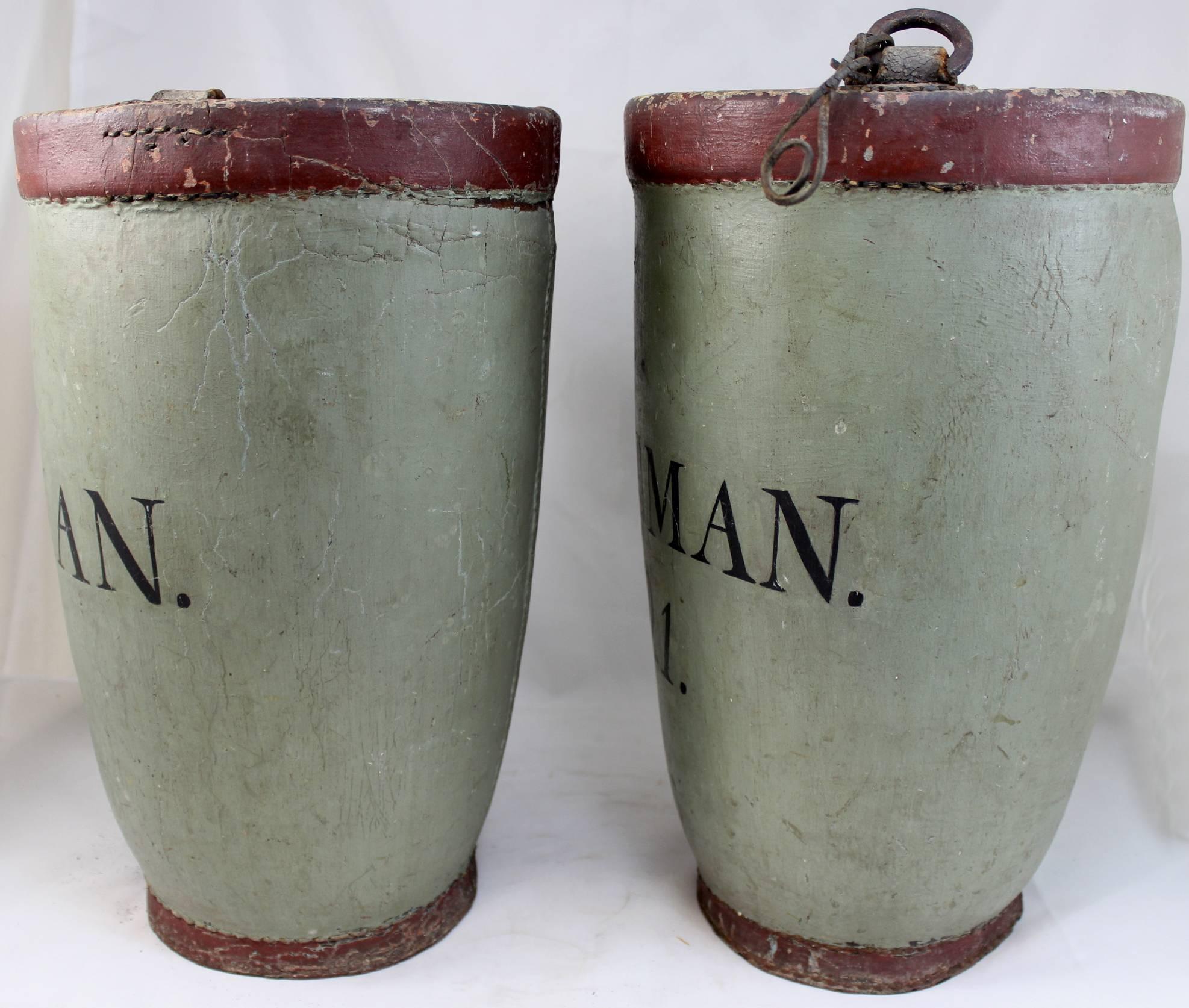 A rare matched pair of 19th century leather fire buckets marked “J-COLEMAN 1821 No. 1 and No. 2”. Each in an original green and gray paint with brick red trim and black leathering. We believe these fire buckets belonged to John Franklin Coleman