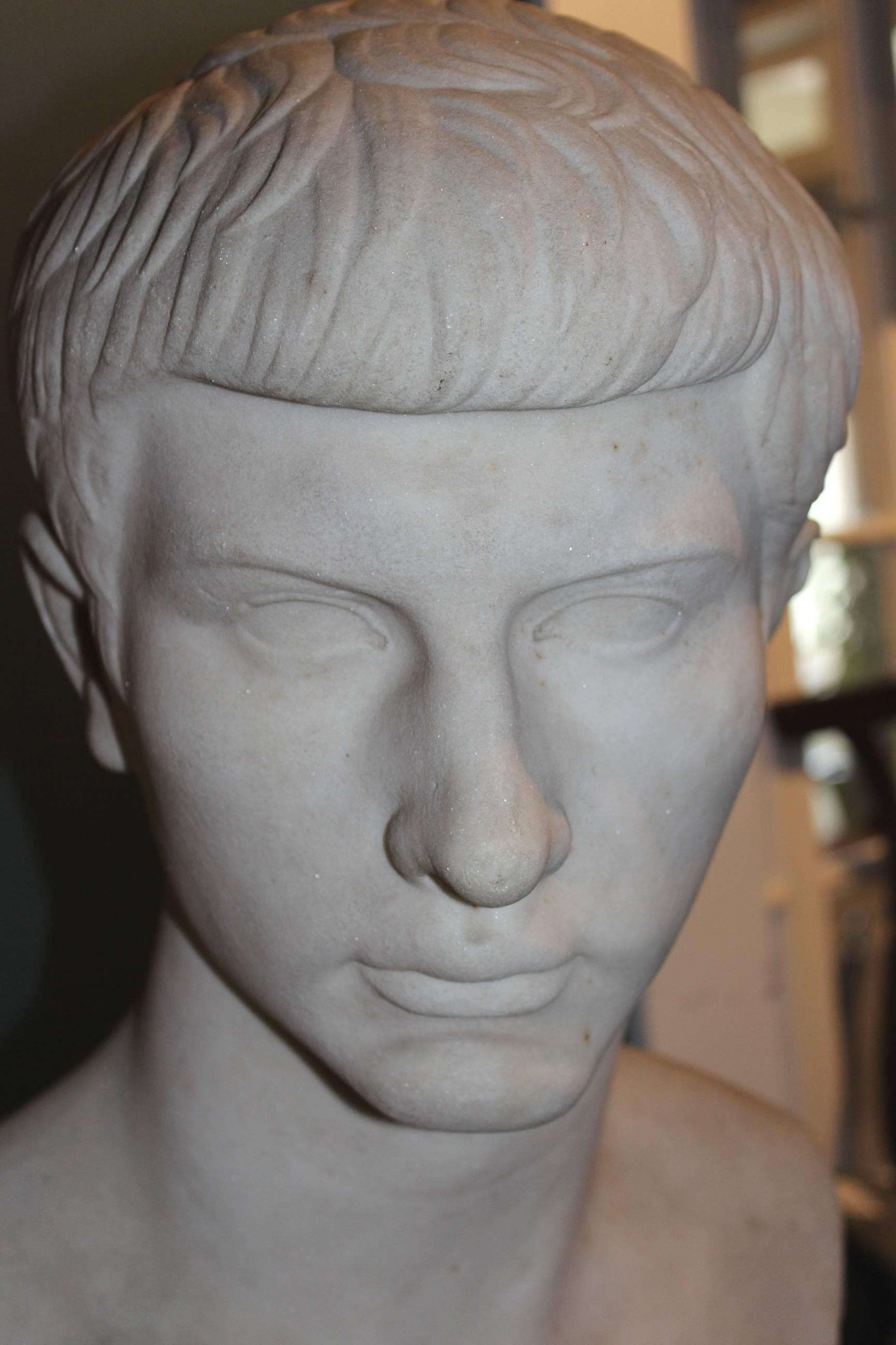 A fine example of a 19th century grand tour marble bust of Caesar attached to a round base or plinth, in very good overall condition, with minor restorations, losses and imperfections including a chip to socle as seen in photographs.