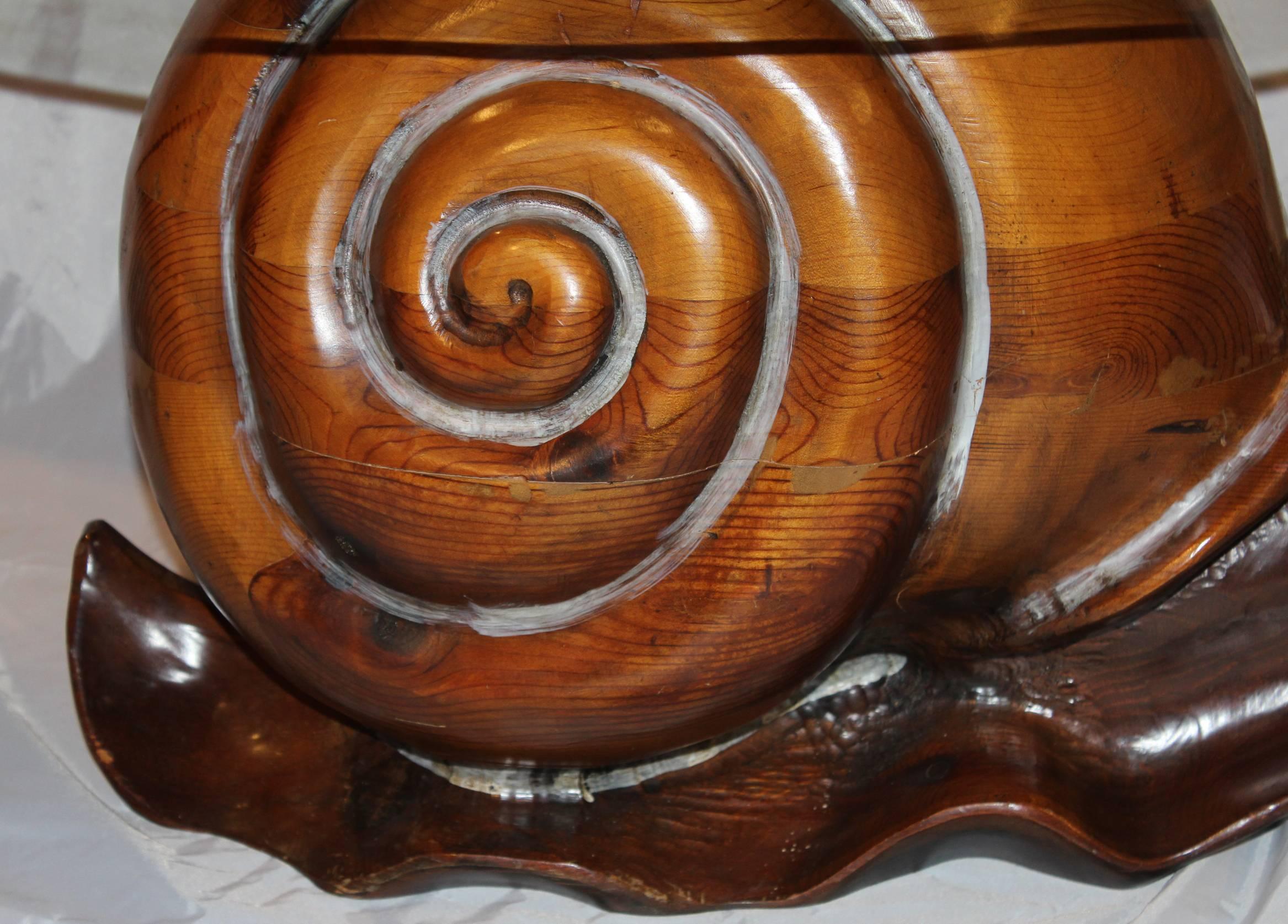 A fabulous carved pine snail table with round glass top with brass center detail by Albuquerque, New Mexico artist Federico Armijo (b. 1946). Unsigned and probably dates to the 1970s. A great conversation starter as a small cocktail, coffee or side