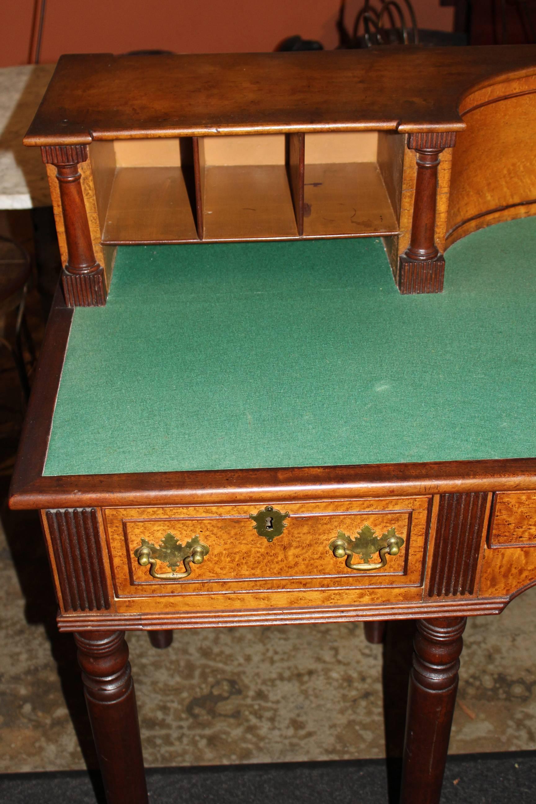A rare early 19th century bird's-eye maple and mahogany state house desk made by Porter Blanchard of Concord, NH with beautifully shaped upper case, felted writing surface, open cubbies and half column pilasters, over a central long drawer flanked