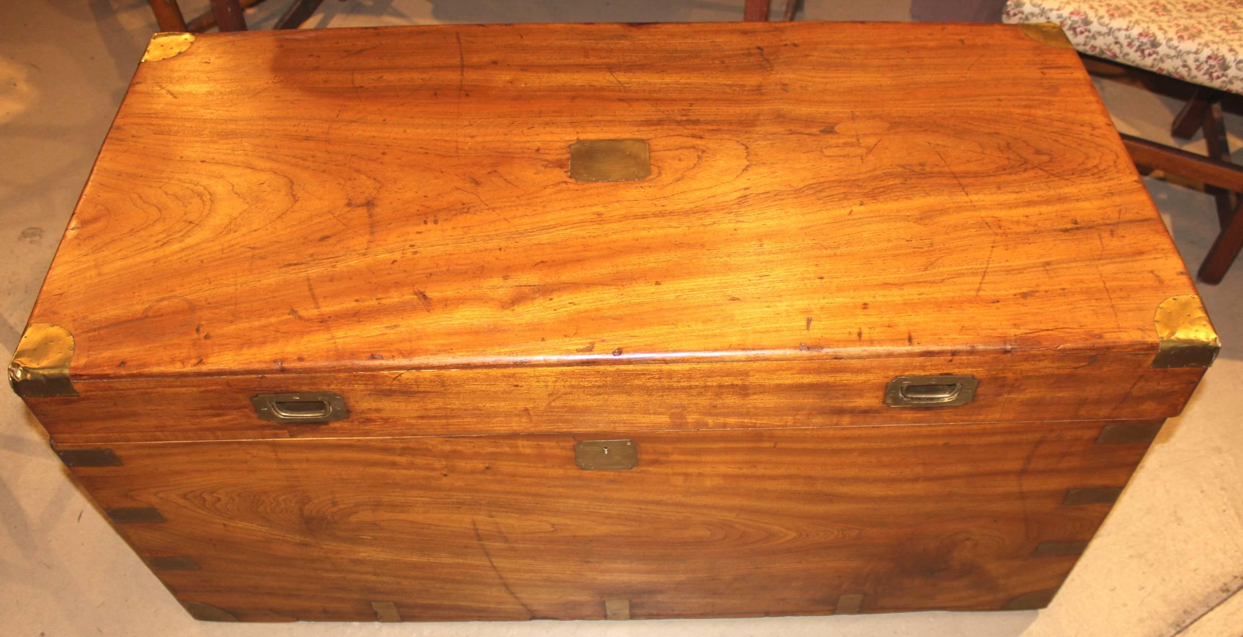 A China trade camphor wood trunk or campaign chest, circa 1800, with brass corner guards and flush-set brass locks and front top handles, as well as end handles, which all appear to be original to the piece. The top brass plate is not engraved. Very