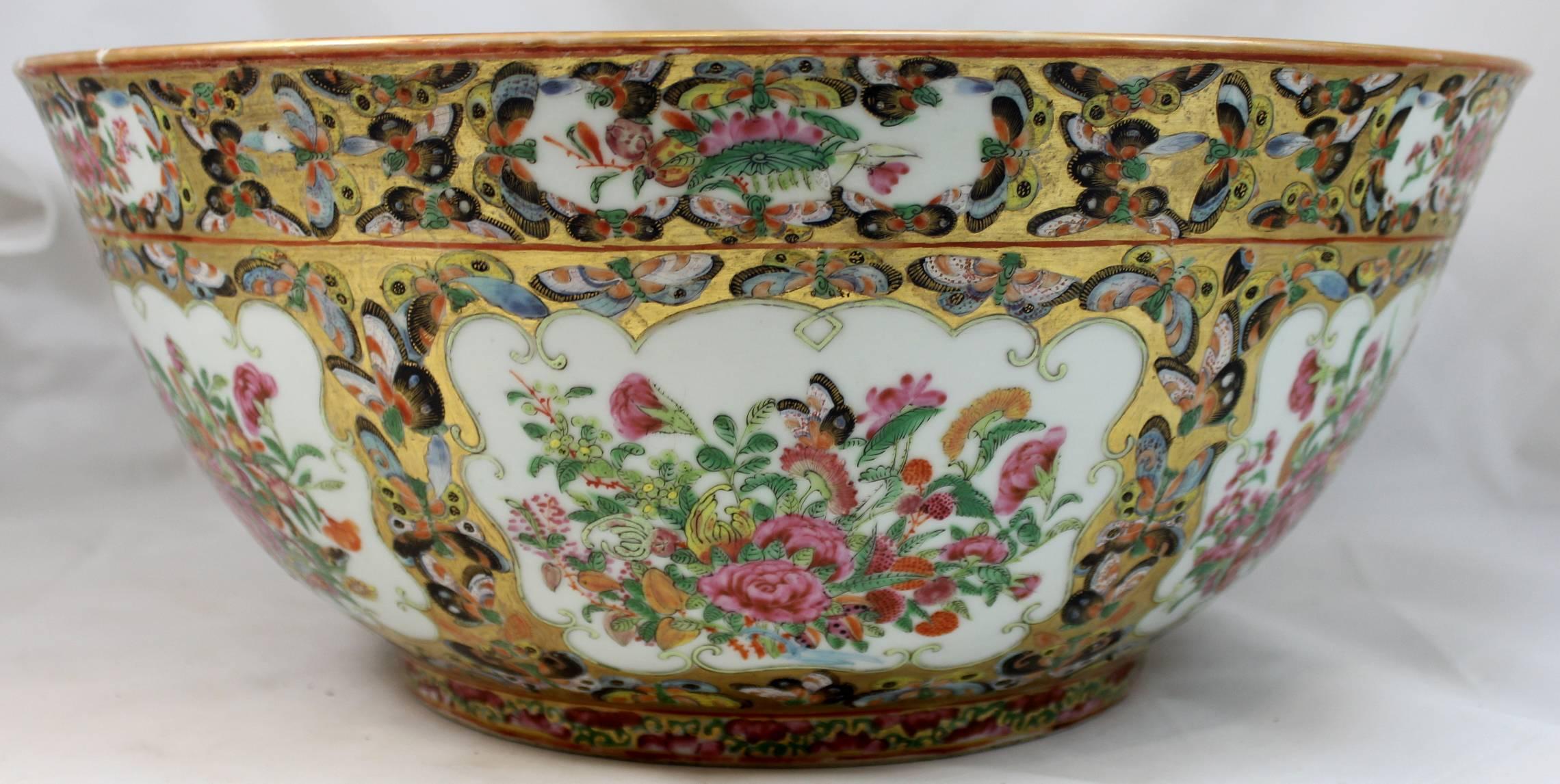 A spectacular example of a Chinese Export black butterfly punch bowl with central foliate round interior panel surrounded by six decorated foliate panels accented with gilt and black butterflies bordering and incorporated into each panel. The