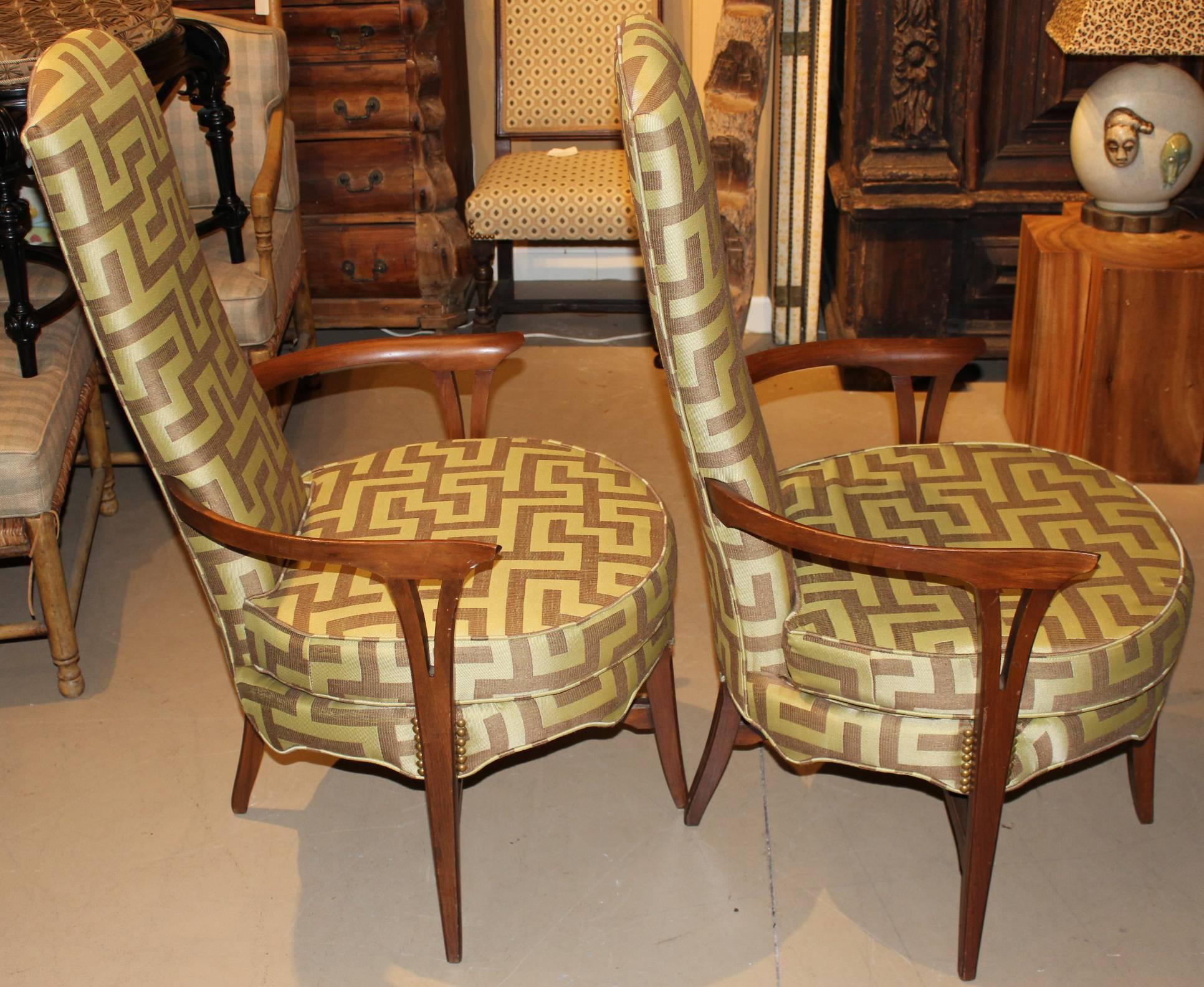 A solid pair of Danish Mid-Century Modern round high back armchairs, unsigned, with removable seat cushions and fresh bold upholstery. circa 1960s.