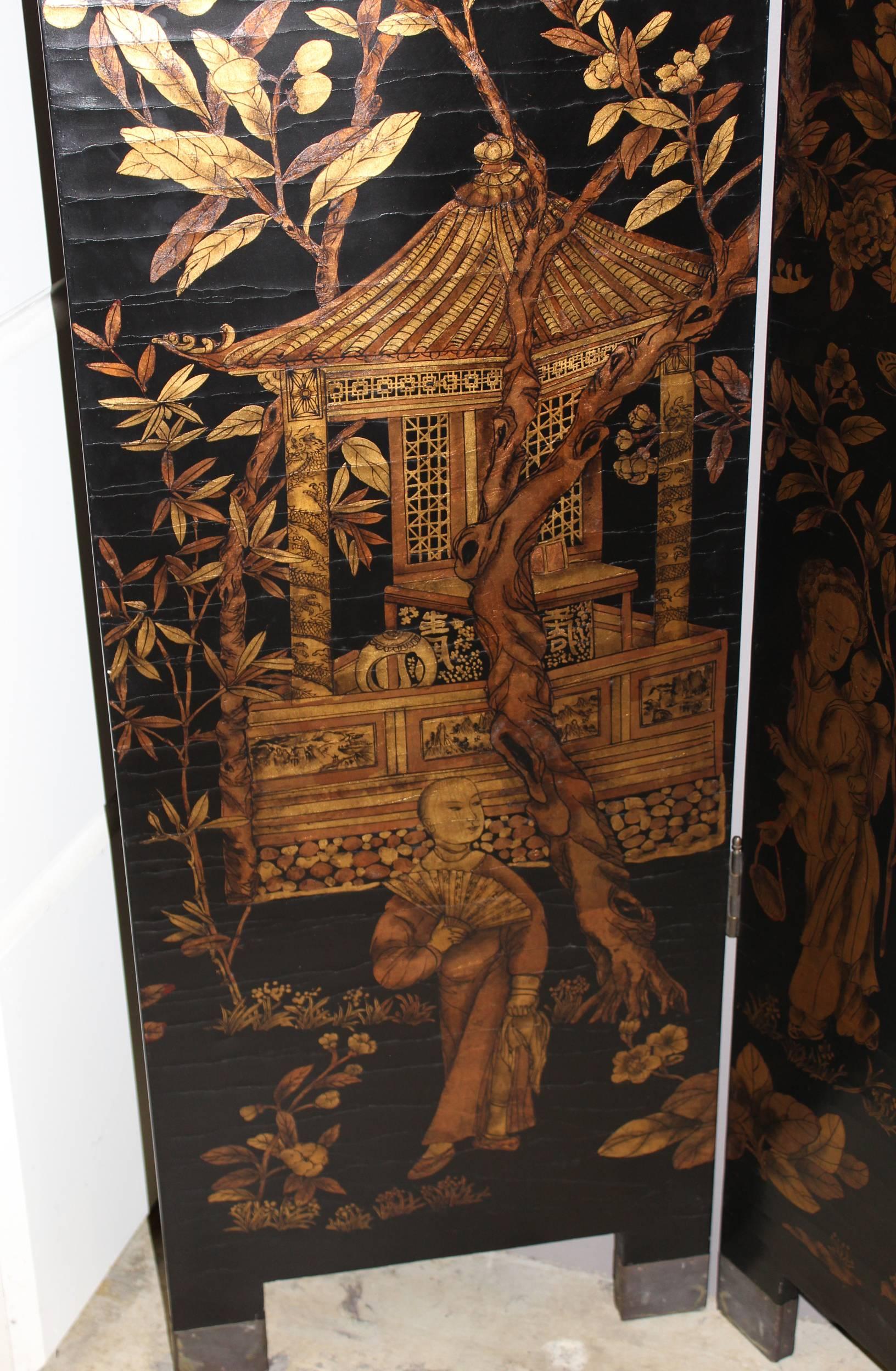 A large Chinese black lacquer and gilt decorated four panel screen, the front depicting gilt trees with several birds, as well as figures and an outdoor pavilion, the reverse depicting bordered foliate scenes of birds and butterflies, all supported