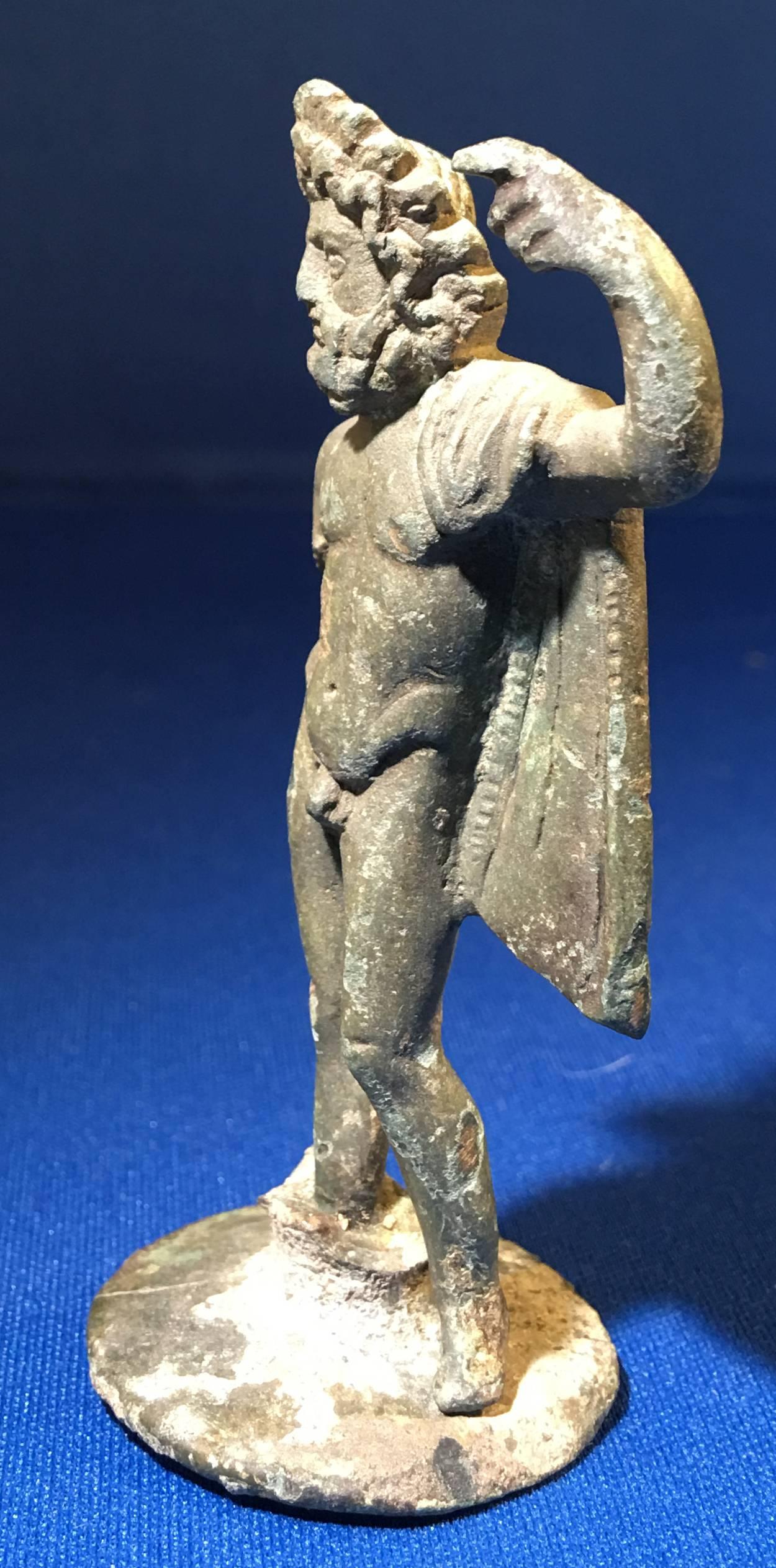 Finely cast well detailed figure or statue of the chief Roman deity, Jupiter. The figure is slender with well proportioned, strong muscular body, front and back. He is bearded and has a thick full head of hair, deeply notched, creating a windswept
