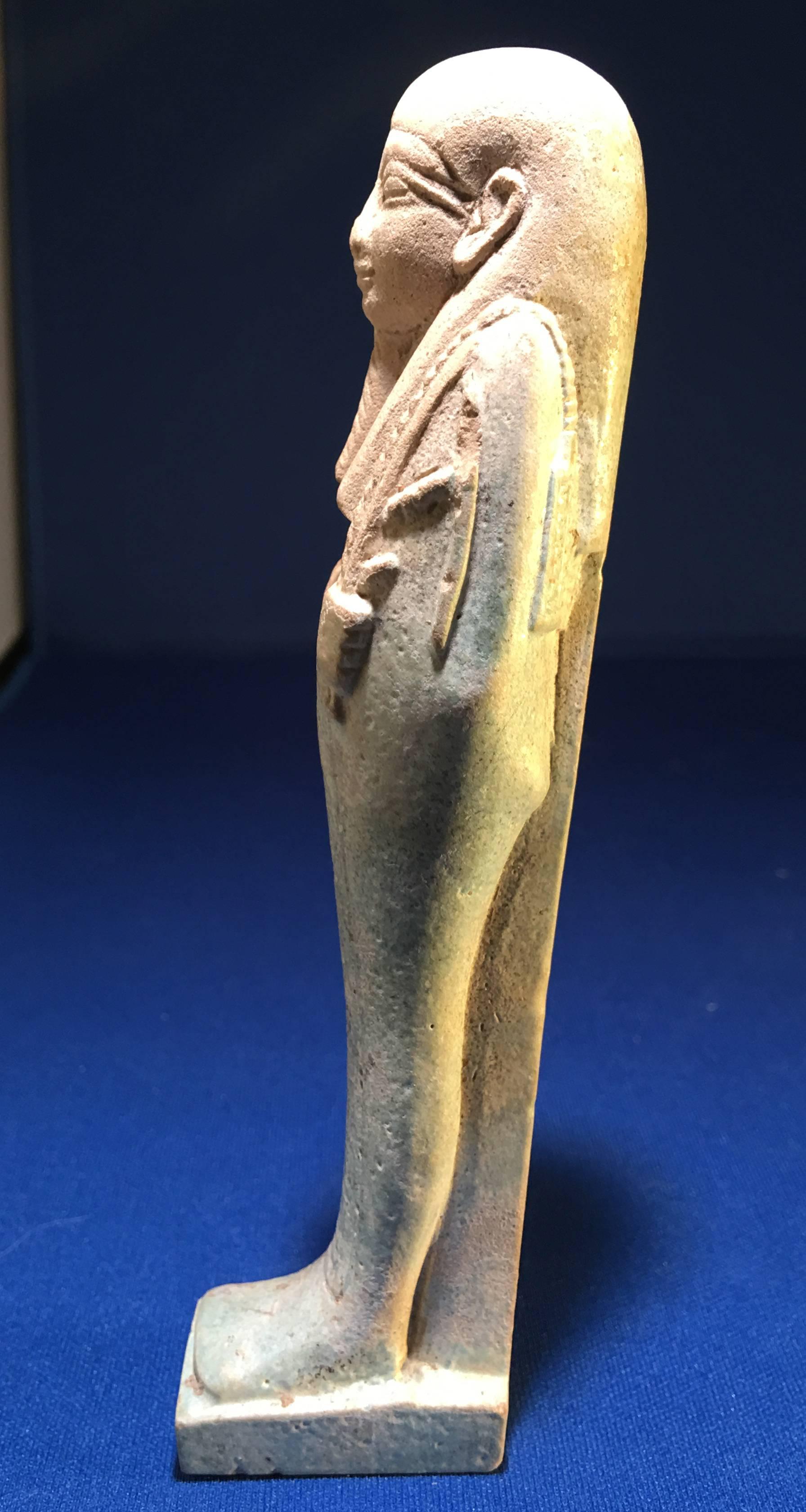 Important green faience ushabti inscribed for Neb-mesu, captain of a naval ship. A single column of frontal hieroglyphics translates as “Instructions of the Osiris, One Belonging to a Ship’s Crew, capable-hearted, Master of Largess, Neb-mesu, the