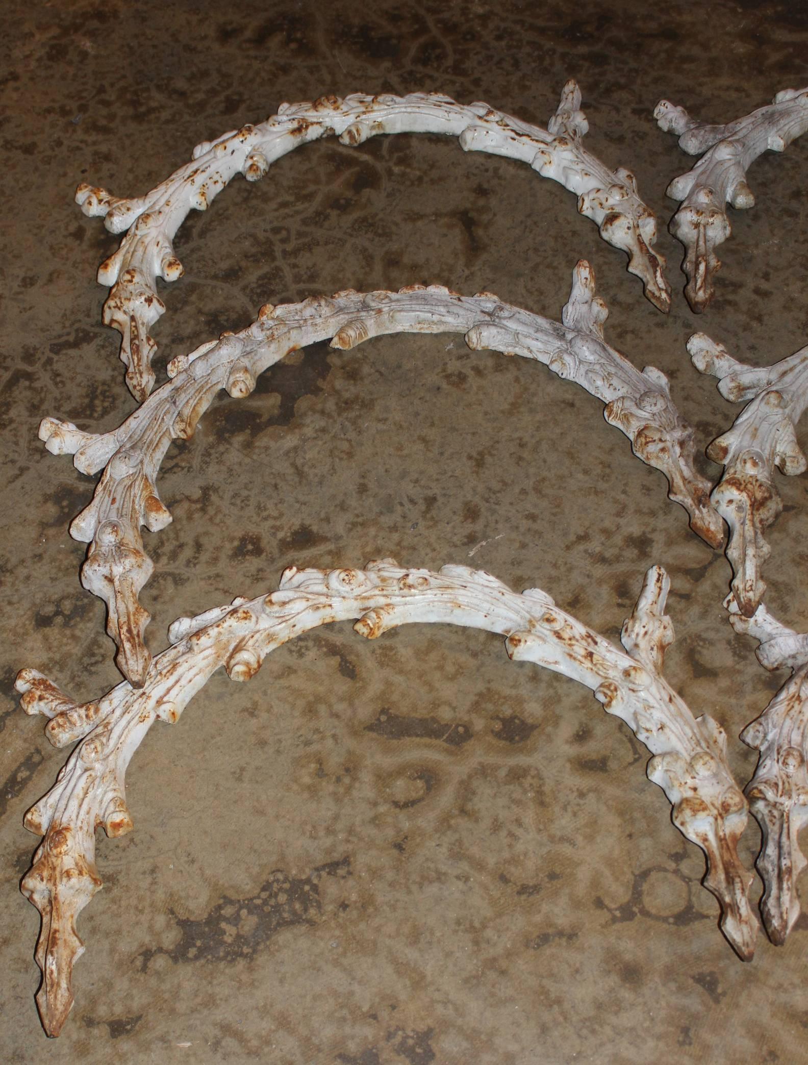 An exceptional 51 piece set of faux bois crescent shaped cast iron garden edges, unsigned, dating to the late 19th or early 20th century. The complete set measures approximately 98 feet in width.