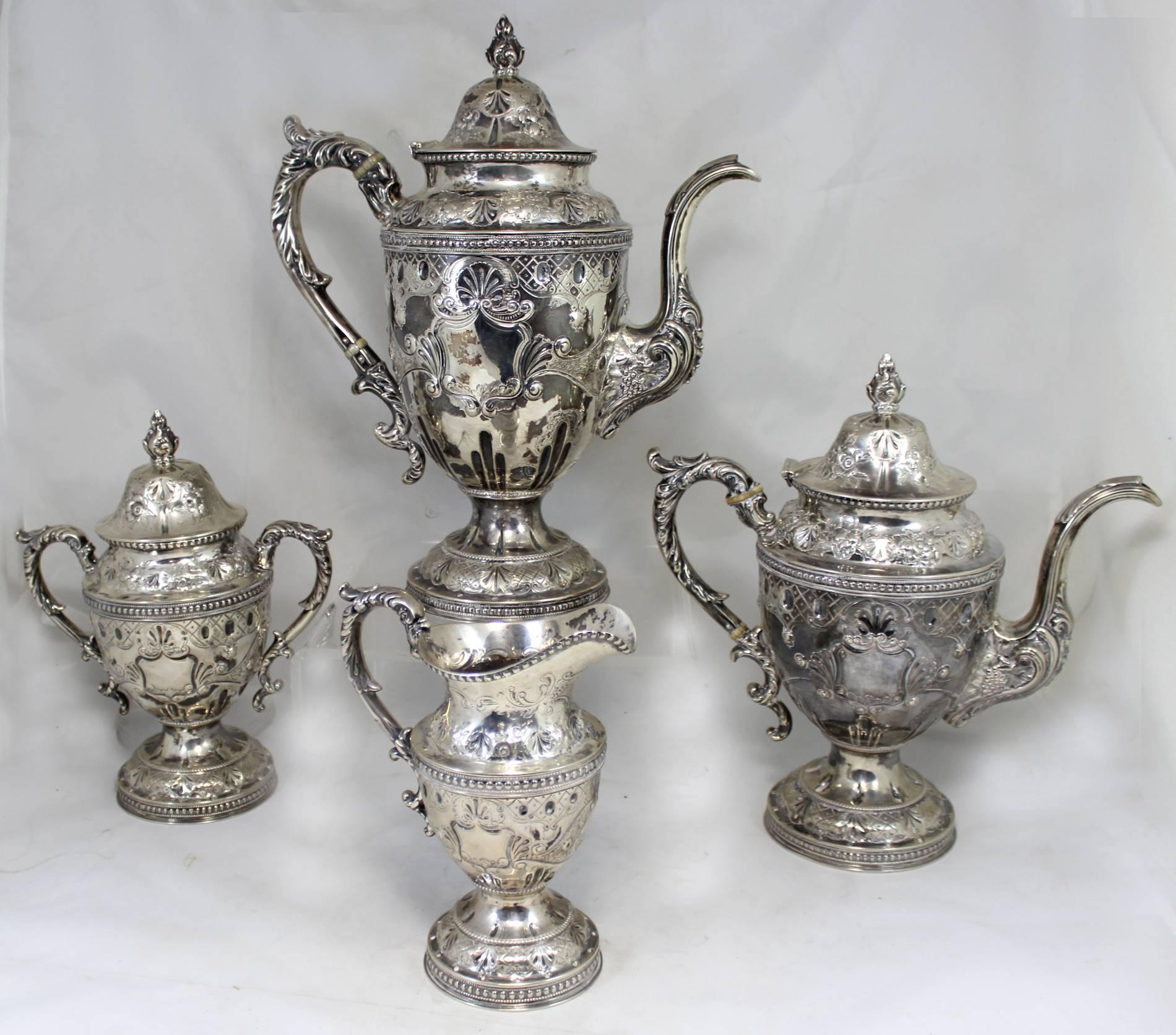 A splendid four-piece coin silver tea service with including coffee pot, tea pot, cream pitcher and covered handled sugar hallmarked by silversmith William Gale and Son, 116 Fulton Street, New York (1853-1866). Exquisite repousse with foliate