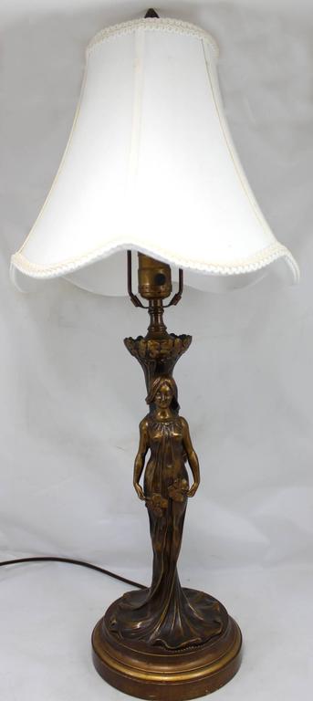 An exceptional French Art Nouveau patinated bronze figural table lamp with of a young woman in a long flowing gown with long hair. Unsigned, stamped with “Paris Louchet Ciseleur” foundry mark. Paul Louchet(1854-1936) was born in Paris, studied with