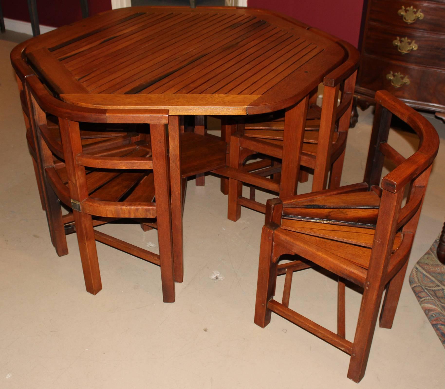 A solid hexagonal teak wood garden table with six custom fitted chairs made by Hughes Bolckow Shipbreaking Company Ltd, Blyth Northumberland, from wood salvaged from Winston Churchill’s Admiralty yacht “Enchantress”. A metal tag for the company