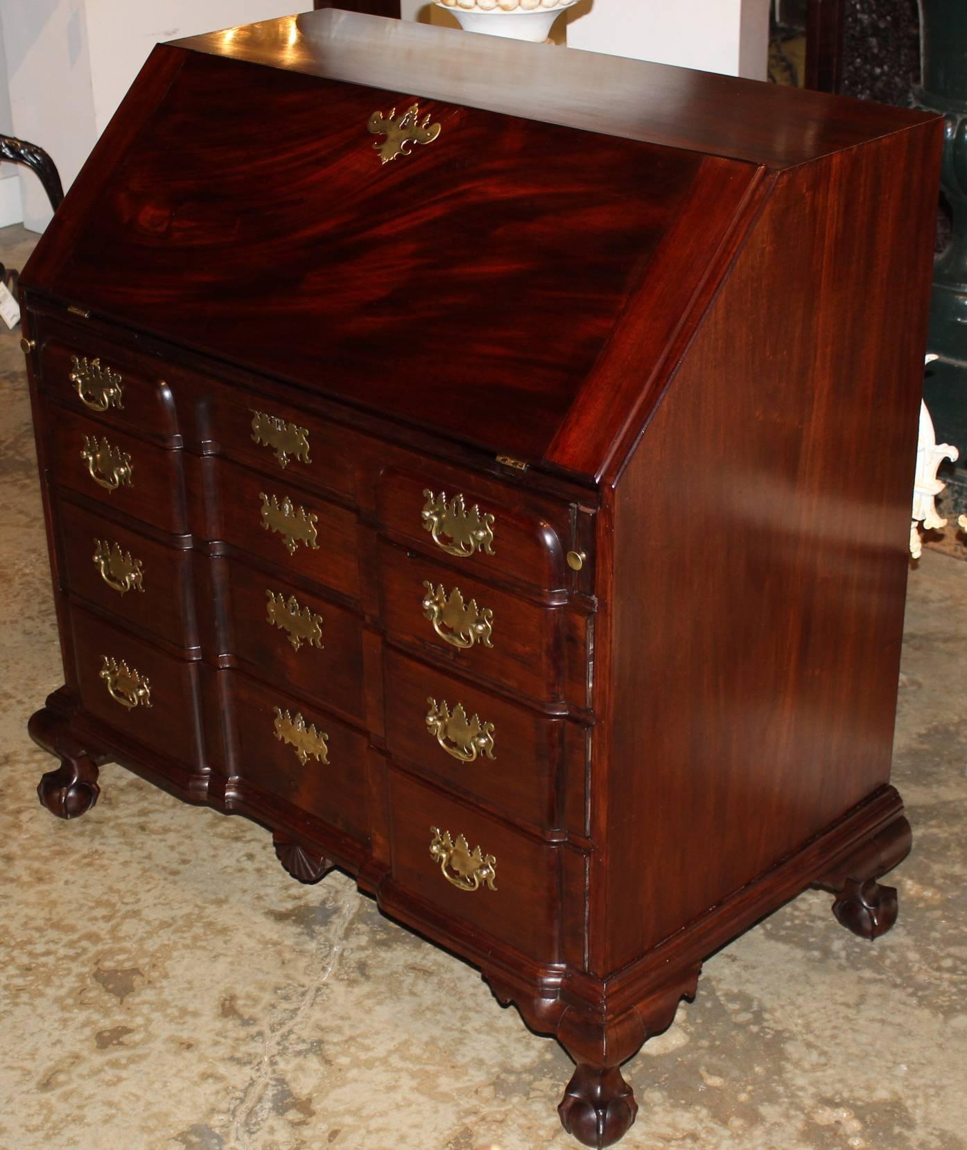 An exceptional block front slant front desk, Boston, circa 1770, in Honduran mahogany with spectacular compartmentalized interior, including hidden document drawers flanking the prospect door. The four blocked and graduated drawers are supported by