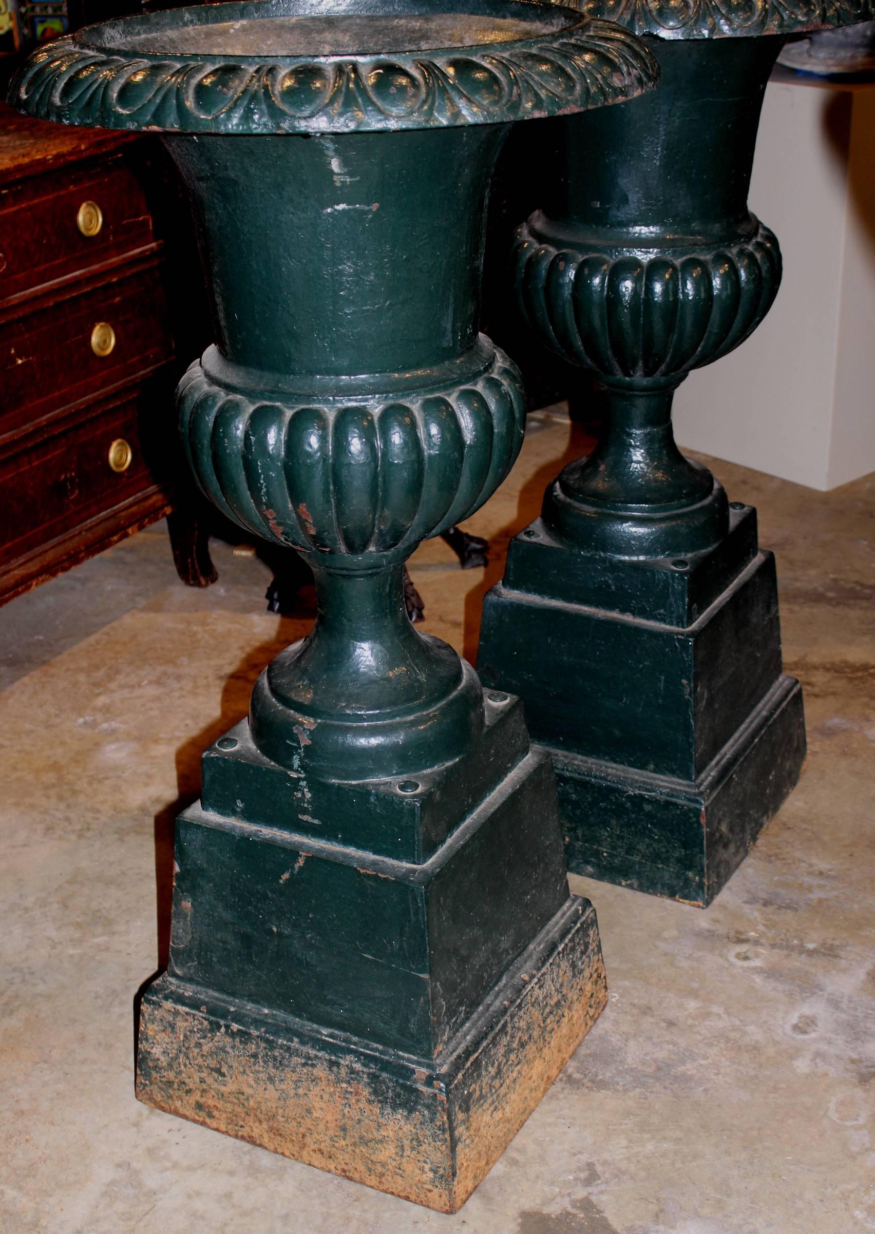 Cast Pair of Green Painted Victorian Iron Urns on Attached Bases
