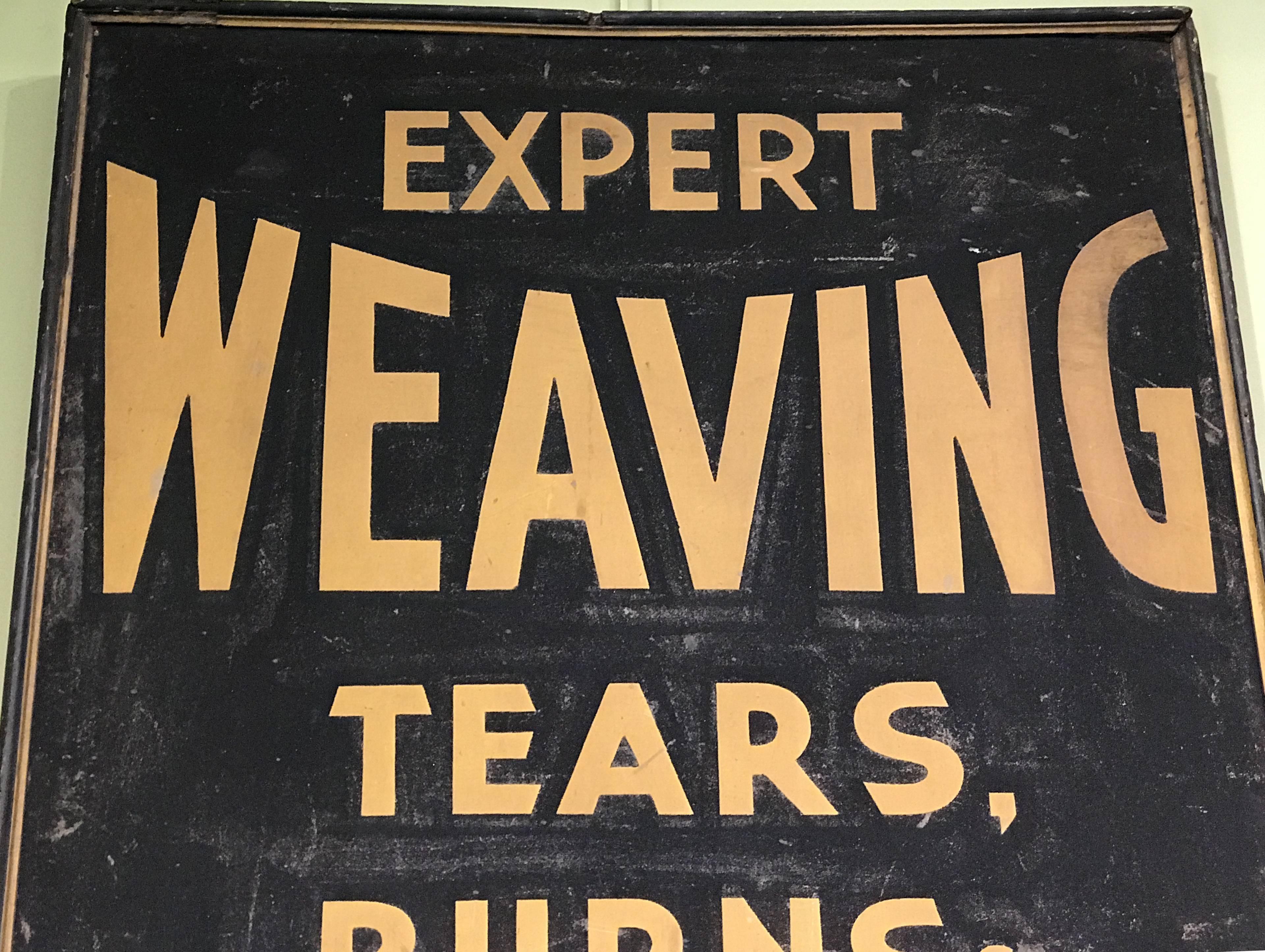 A large black and gold sand painted tin SoHo District New York City advertising trade sign for expert weaving with pointing hand indicating location No. 66, inscribed on verso County sign Co. Good overall condition, with some wear and losses on the