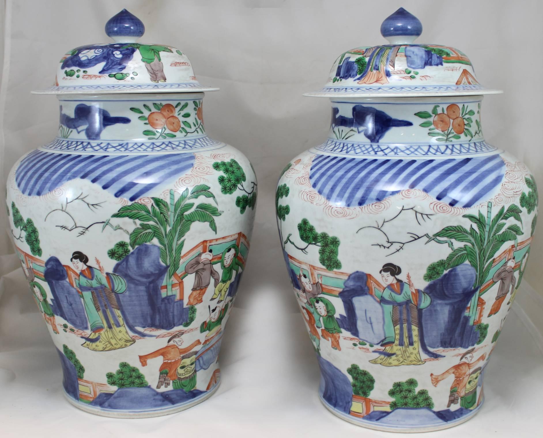 A fine pair of Chinese Qing Dynasty polychrome covered porcelain jars with overall scenes of children at play with mothers looking on, probably dating to the late 19th century.