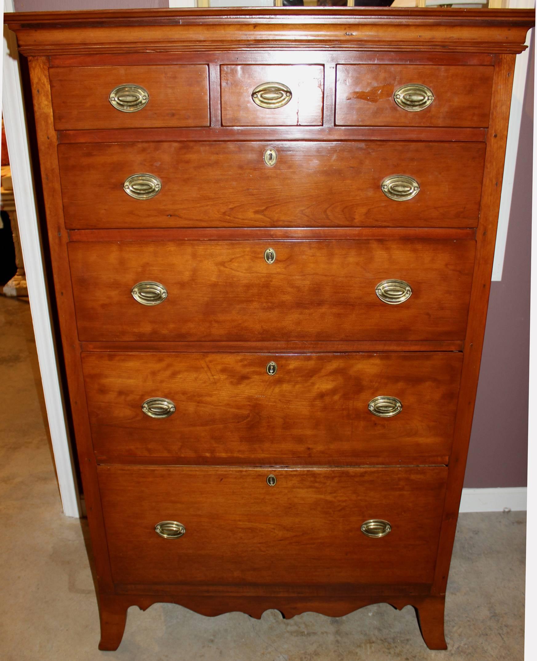 A wonderful example of a late 18th early 19th century transitional Pennsylvania three over four tall chest with great proportions, with graduated drawers, oval brass pulls, supported by French splayed feet. The top three fitted drawers were