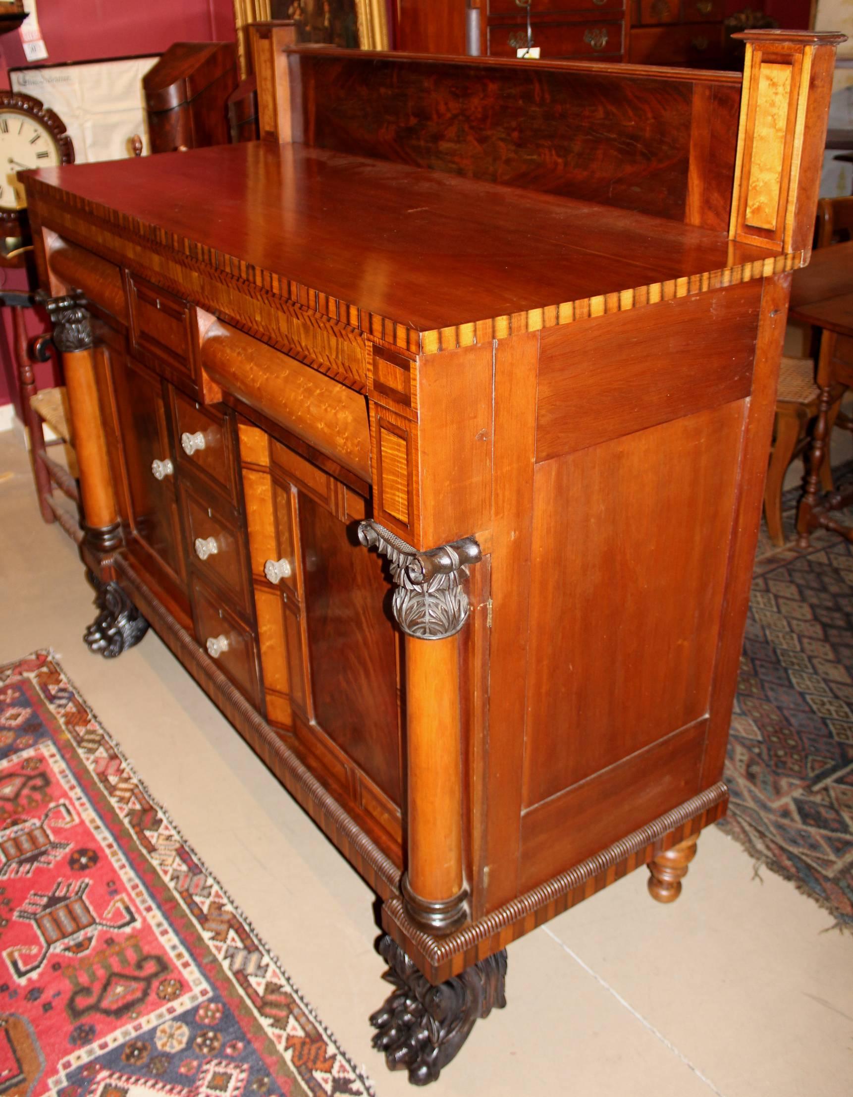 An exceptional American Empire mahogany server with superb checkered and banded inlays and veneers in satinwood, tiger maple, bird's-eye maple, and bookmatched mahogany, with four central banded bird's-eye veneered drawers flanking two fitted