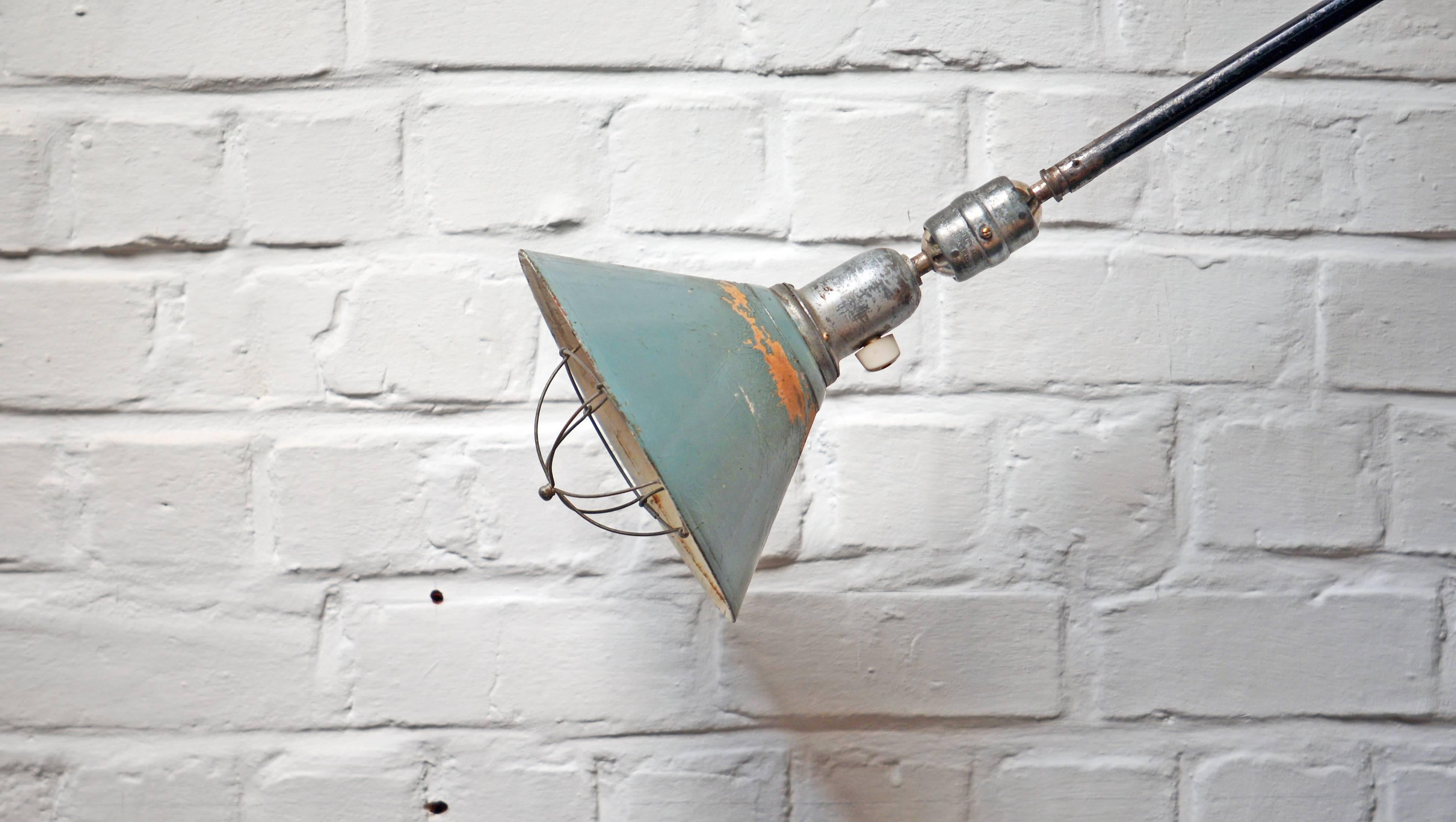 Johan Petter Johansson very rare first edition of the Triplex telescopic lamps with three arms and a weight in metal and porcelain. The lamp can swing from left to right and from up to down. It can be extended to 320cm! The original cap is made of