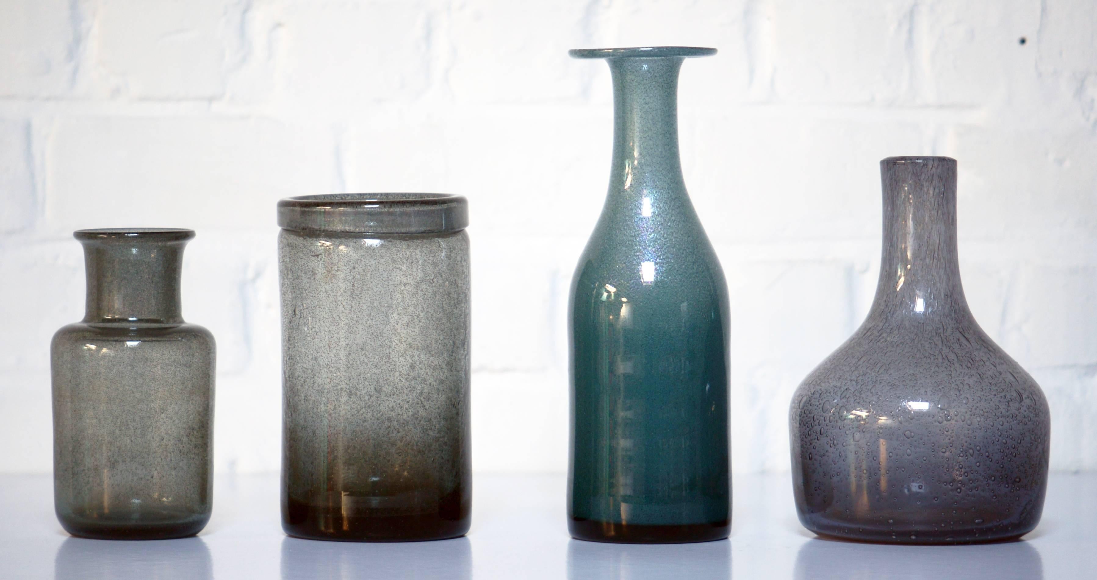 Erik Hoglund handmade vases by the Artist for Boda, Sweden.

Measures: Blue vase 26cm high and 8cm.