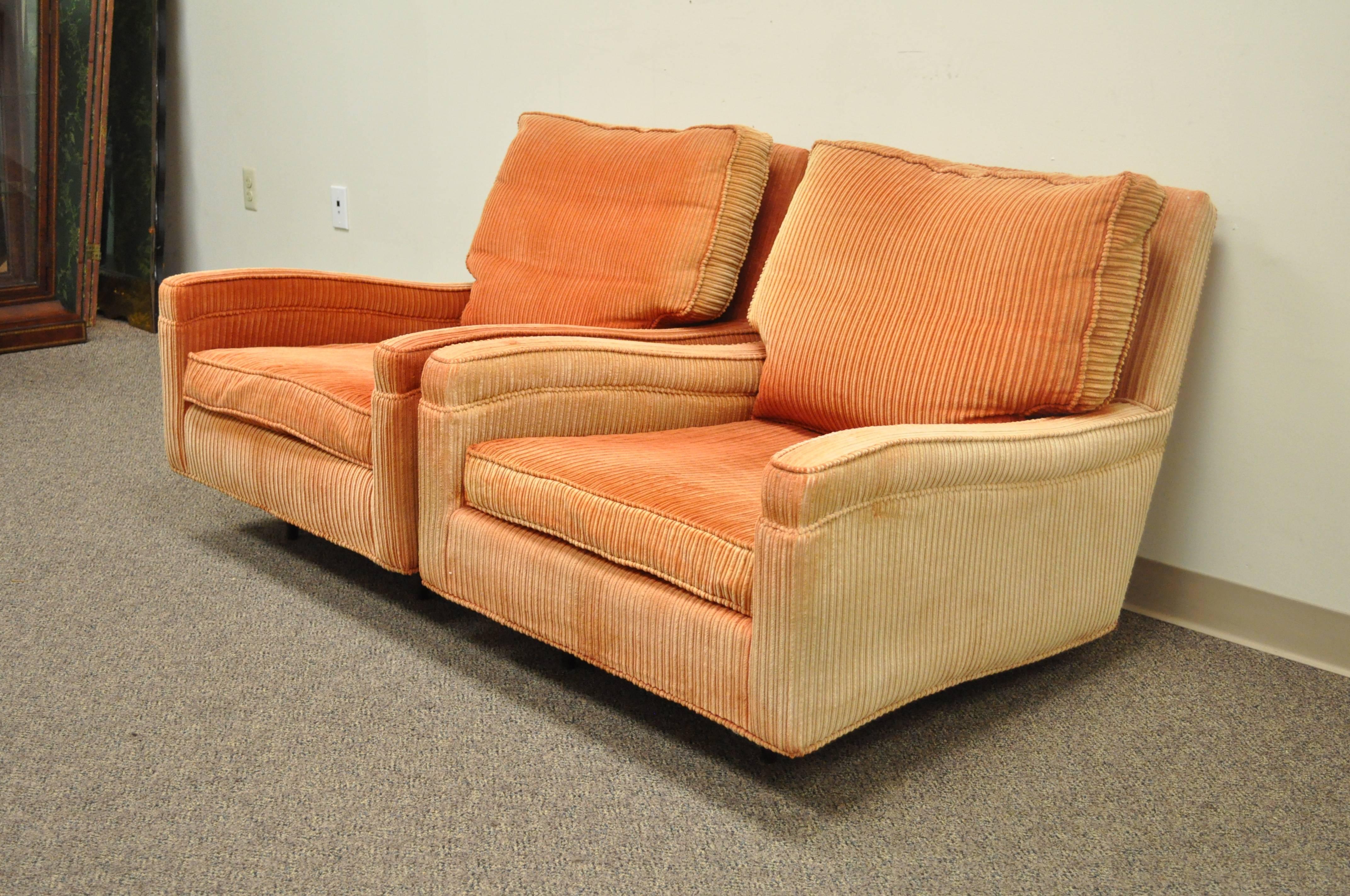 Remarkable pair of Vintage Club or Lounge Chairs by Harvey Probber, circa 1957. The chairs features deep solid wood upholstered frames, sculpted arms, solid wood tapered legs, loose cushions, and stunning modern form. 