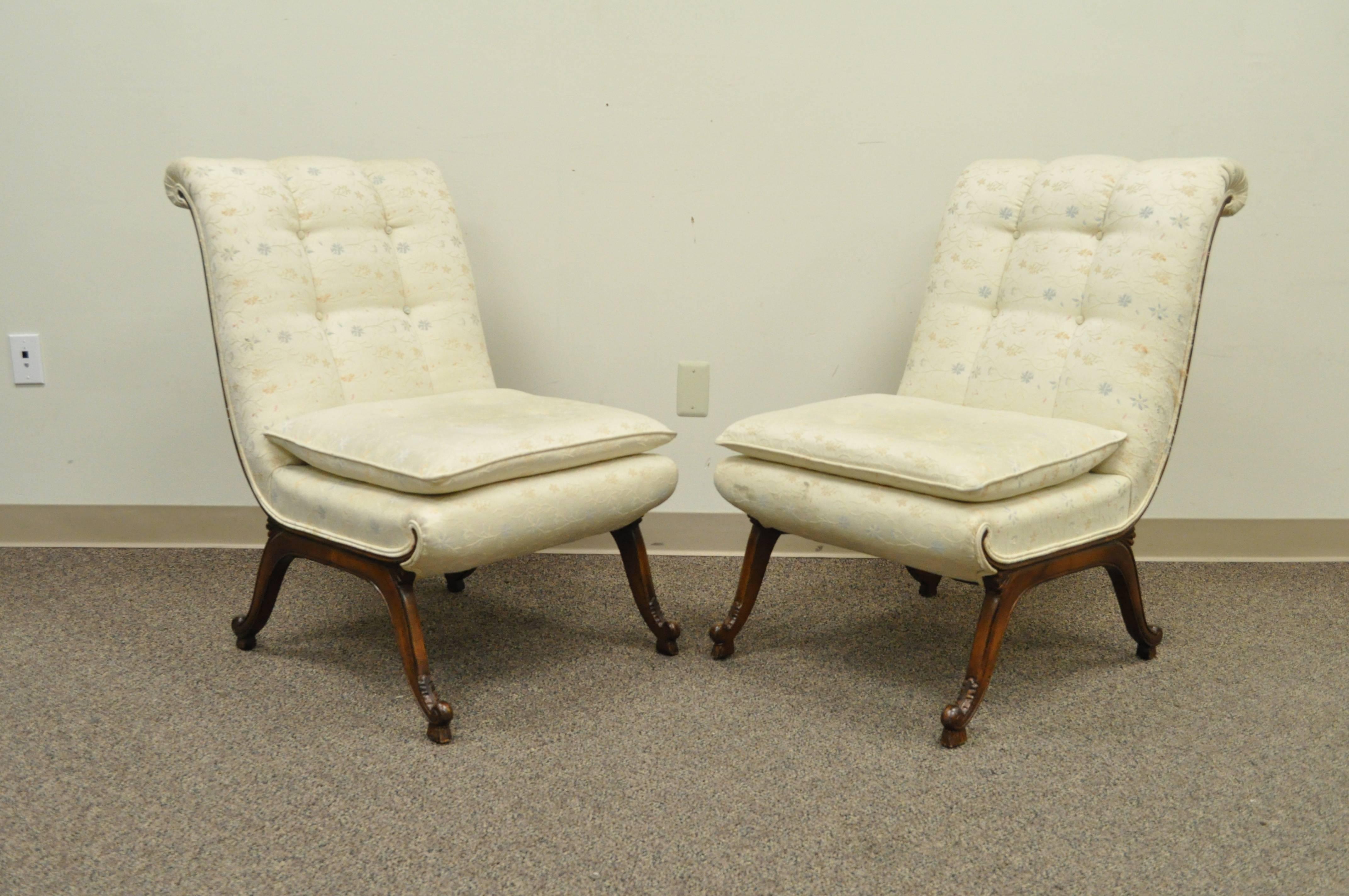 Unique pair of vintage Hollywood Regency, French style, slipper chairs in the style of Dorothy Draper. The chairs feature rolled backs, exposed wood frames, lightly carved feet, and great overall form.