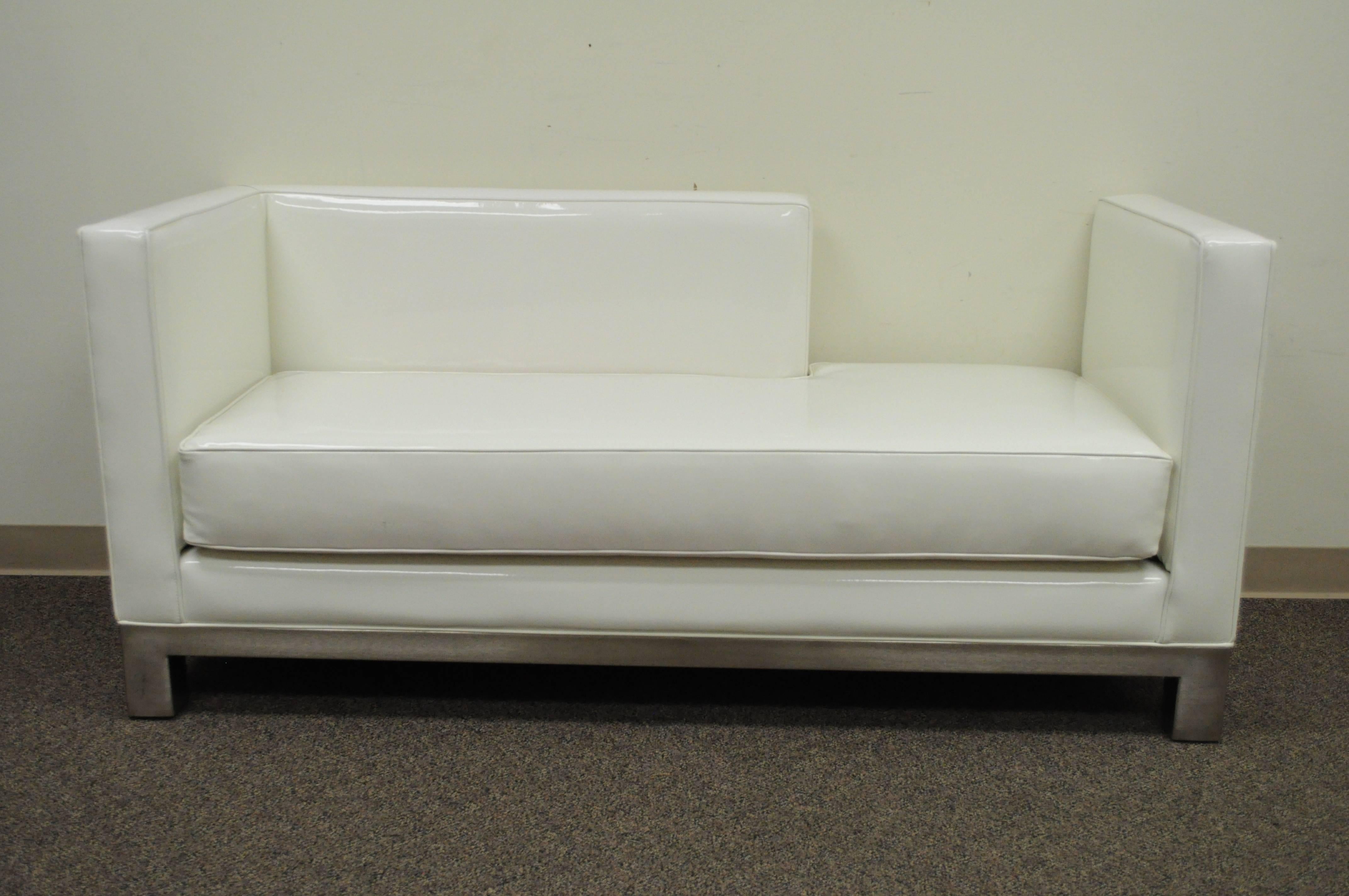Unique pair of right and left white vinyl and brushed metal chaise lounges or sofas by J.A. Casillas. Items feature a sleek contemporary modern design raised on brushed metal bases. Price is for the pair.
