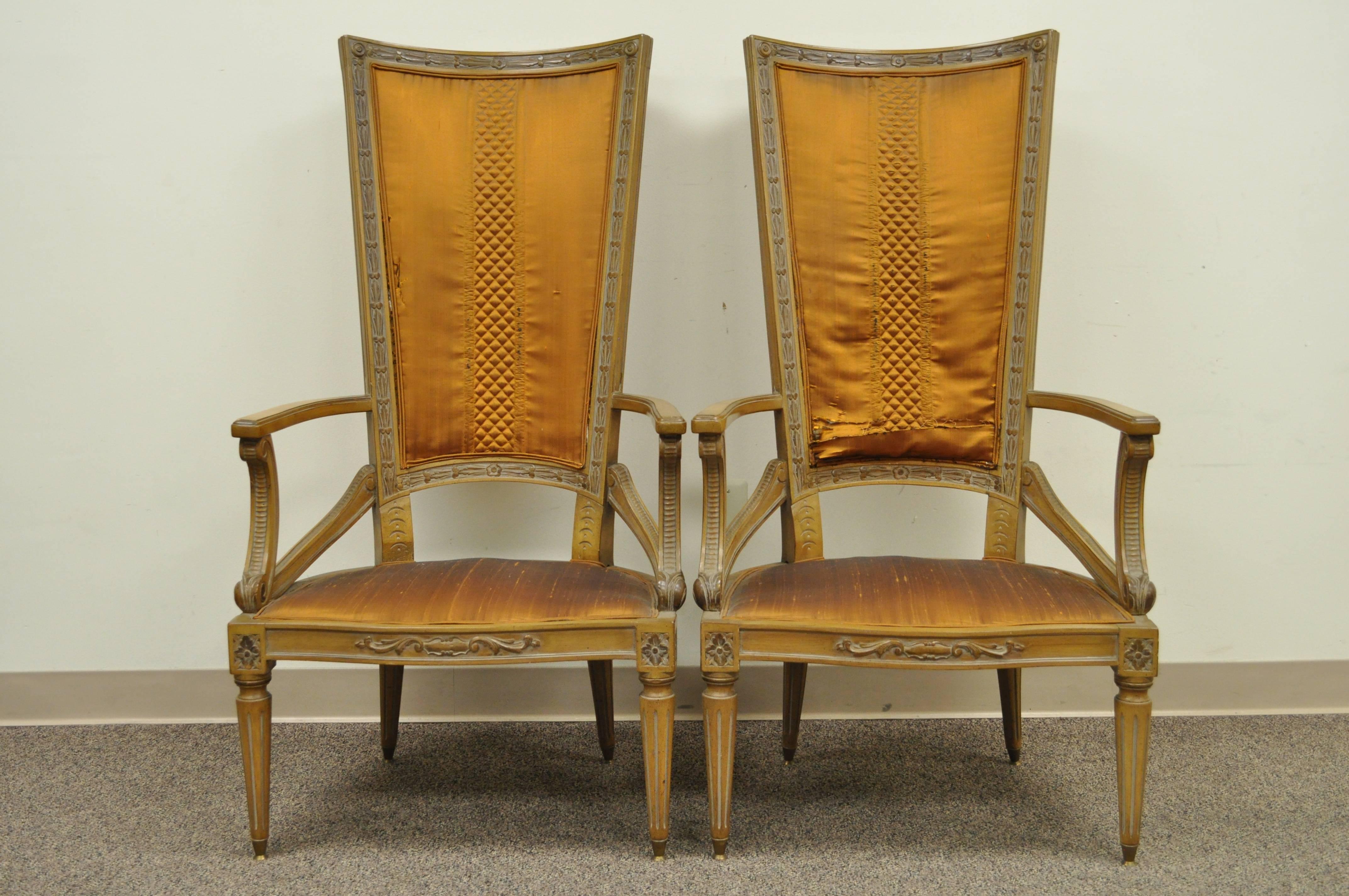 Stunning pair of vintage Hollywood Regency tall back fireside armchairs. The pair features shapely carved open frames, reeded and tapered legs, brass capped feet, and great form. The maker is unconfirmed but the quality and design is very similar to