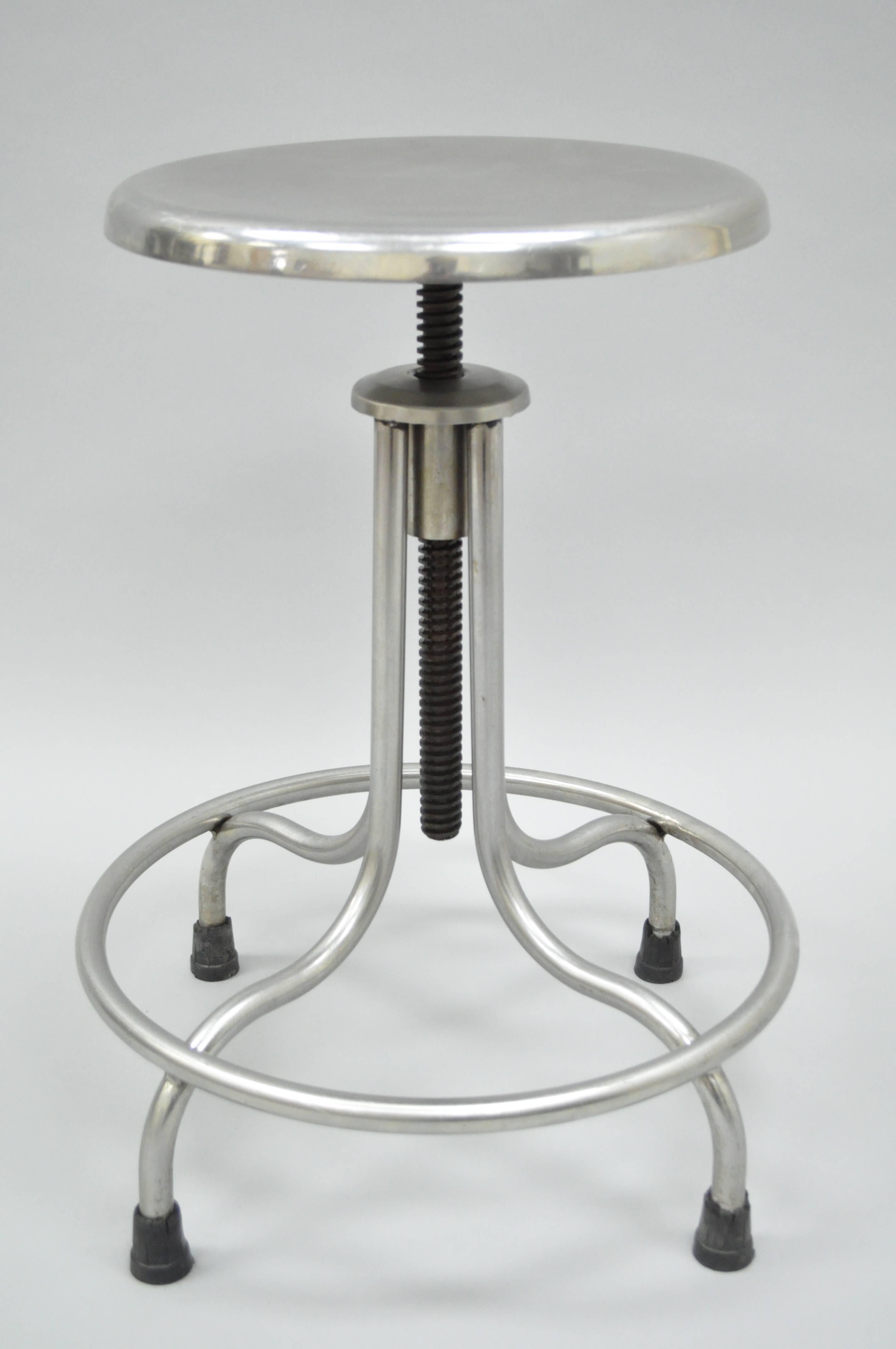Set of eight original vintage stainless steel swivel adjustable height stools/bar stools with footrests by Atlantic Alloy Industries Inc. (AAI) of Union, New Jersey. These well-constructed American made medical or dental stools feature a polished