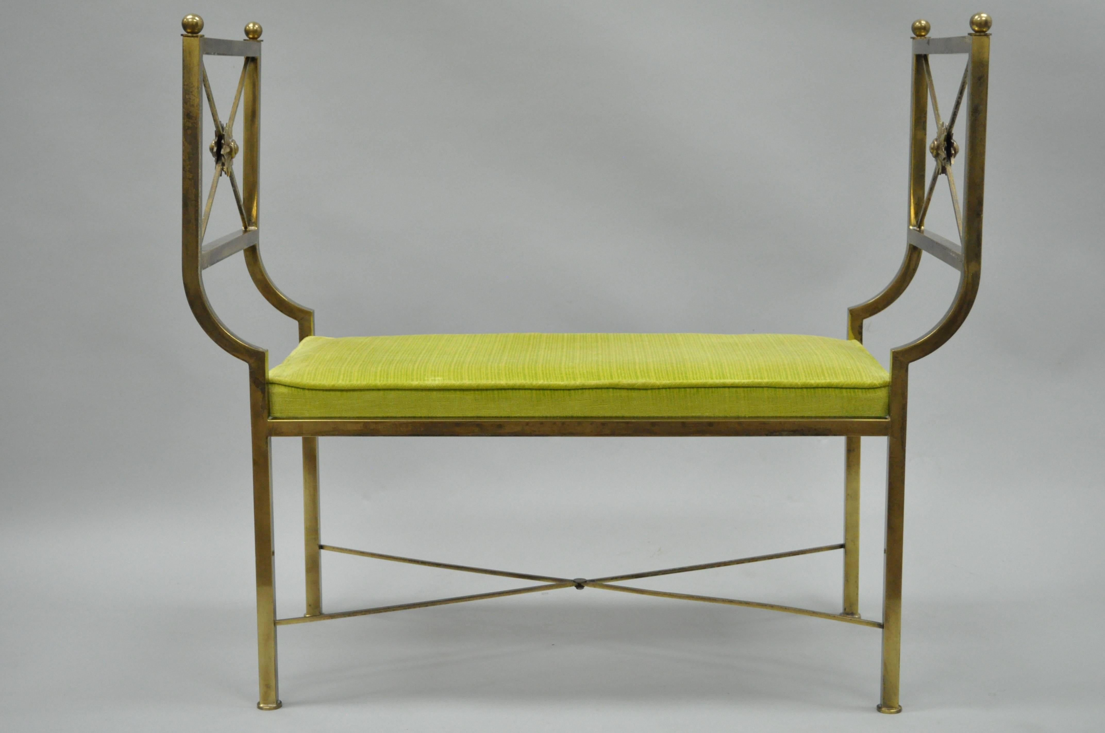 Very unique vintage brass X-Form bench in the Regency style. This item features an X-form stretcher base, clean lines and a burnished brass finish.