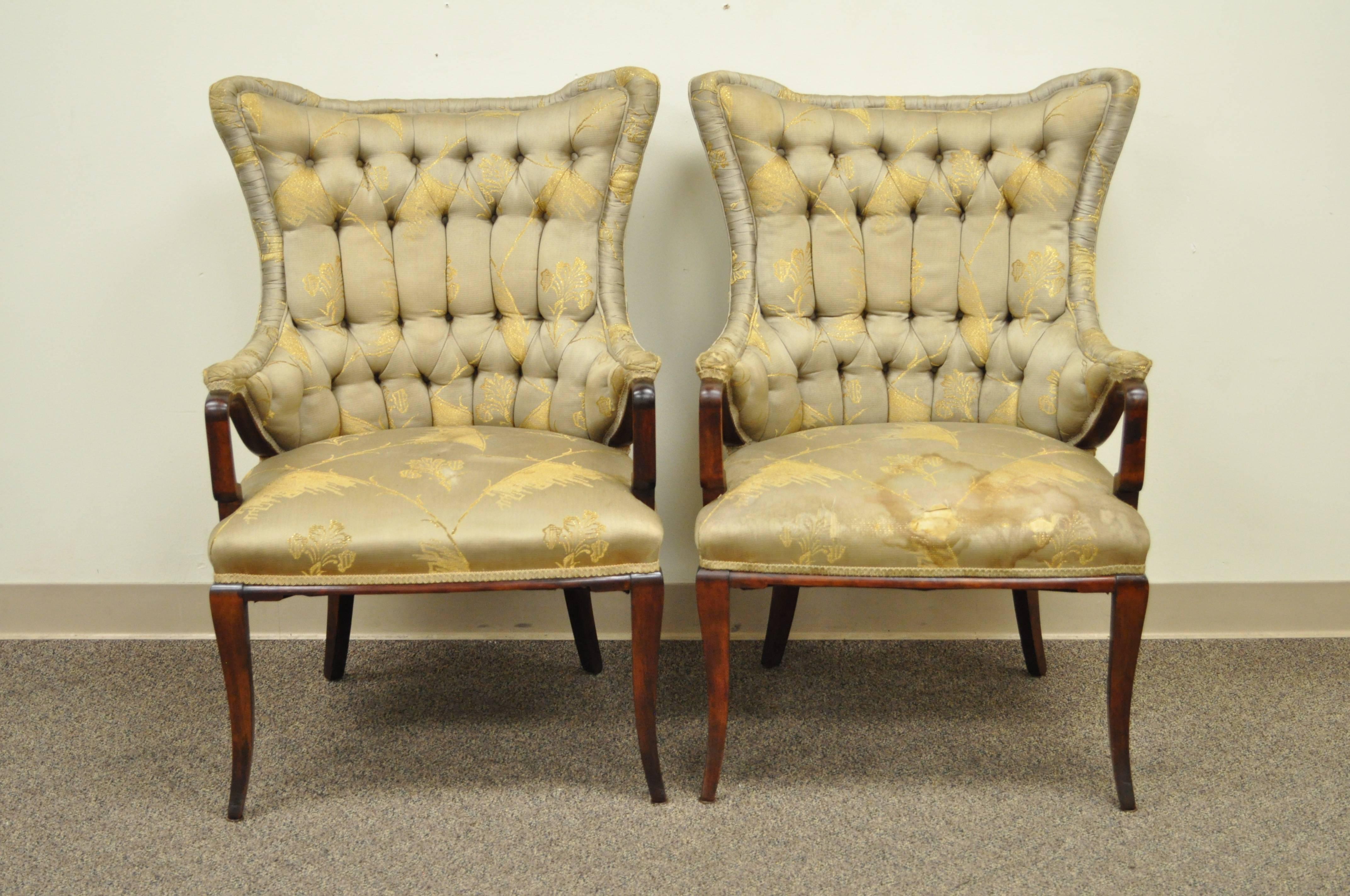 Quality pair of 1940s mahogany fireside armchairs attributed to Grosfeld House. The pair has a very unique Chinese Chippendale style with shaped wingbacks and tapered legs.