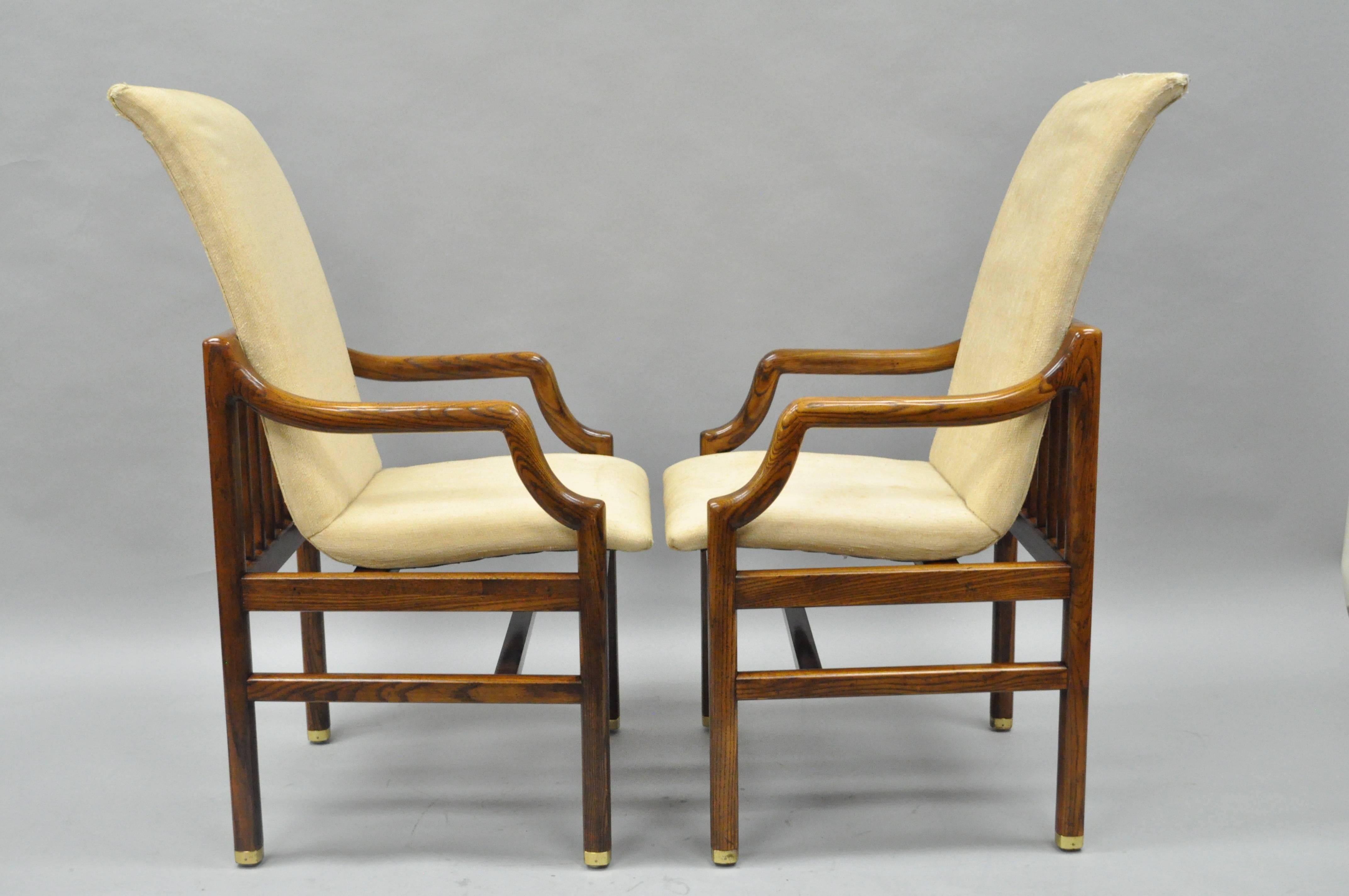 Pair of Vintage Mid-Century Modern Sculptural Arm Chairs by Henredon. Chairs feature solid oak wood floating form frames, tall sculptural backs with ladder back support, brass capped feet, stretcher bases, and attractive overall form. The style of