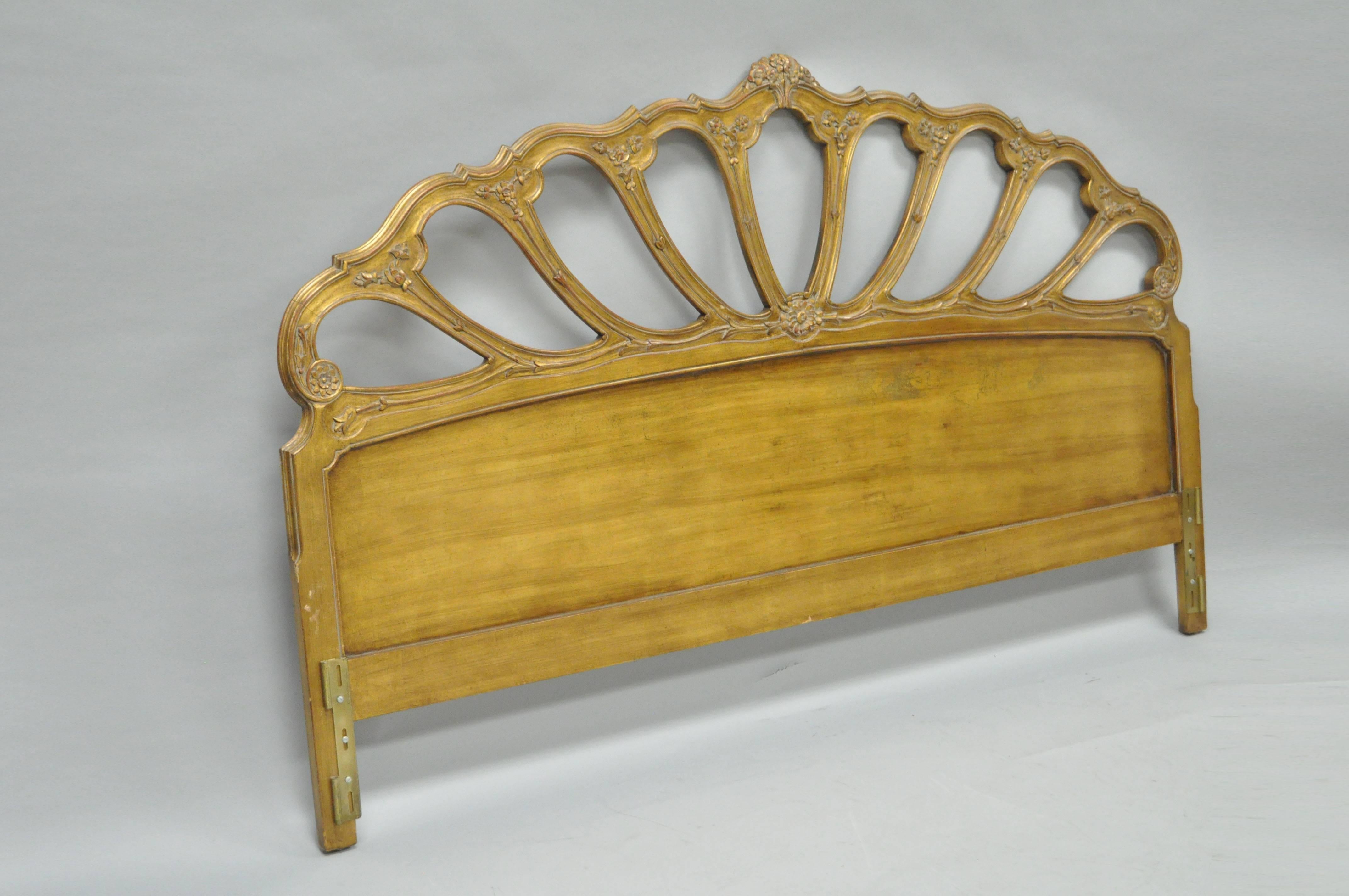 Vintage Italian gold leaf giltwood king-size headboard. Item features a solid open carved wood frame, gold leaf finish, floral detailing, and attractive form.