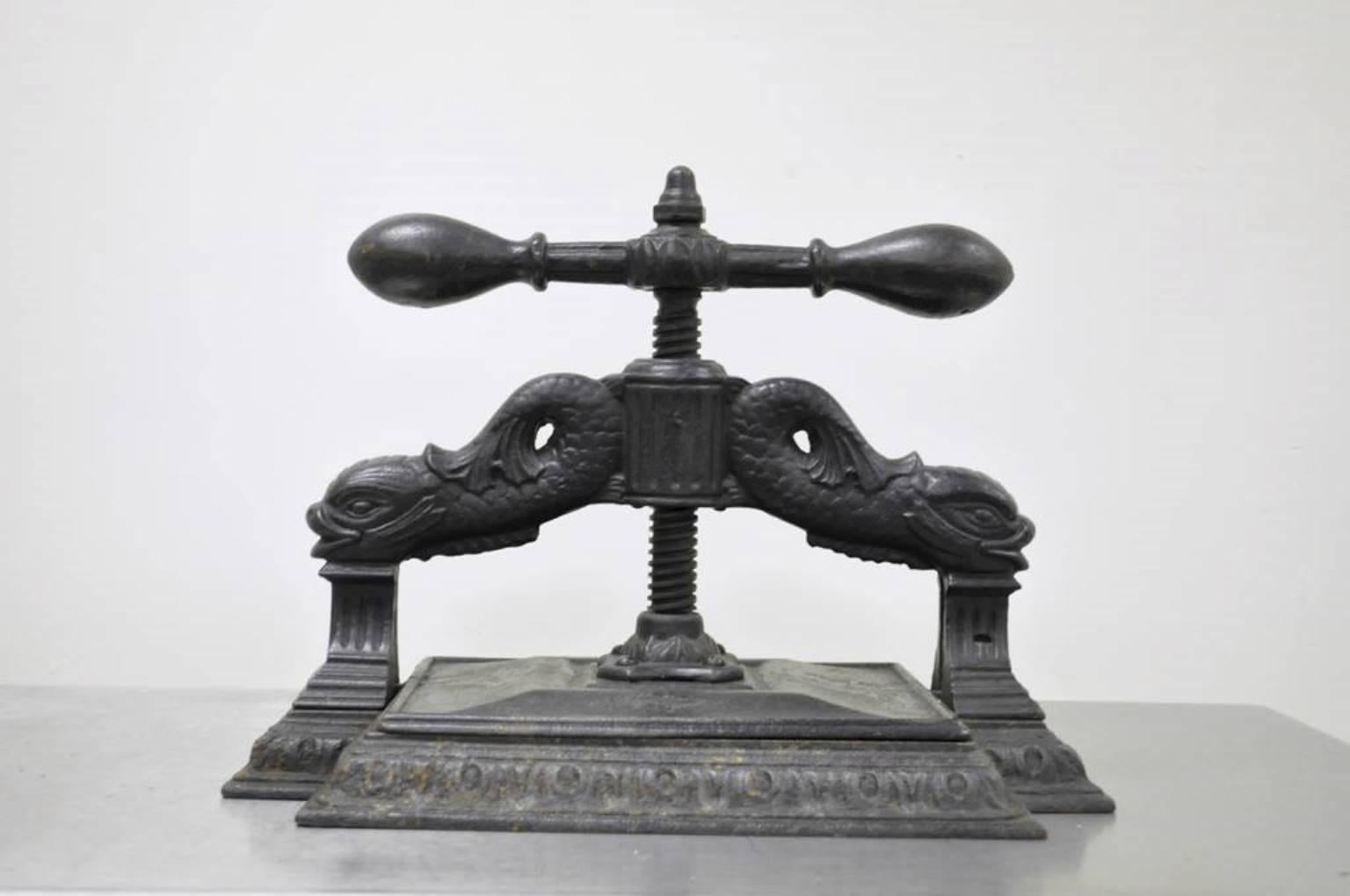 Very unique and historically important antique cast iron dolphin book/copy press. The piece features intricate supports with dolphins and fluted columns, and acanthus accented base. The press is very substantial and heavy, and though it does not