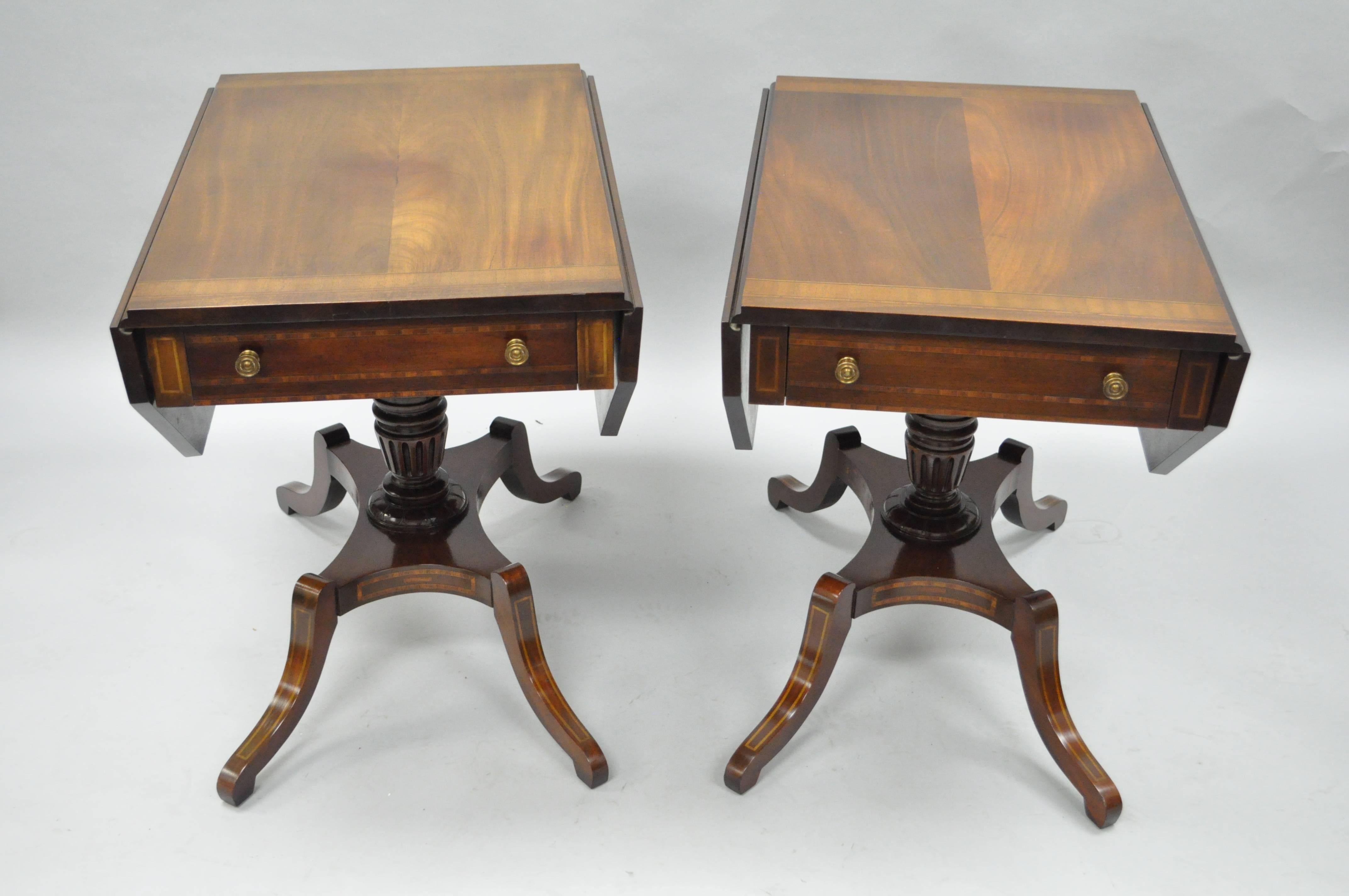 Pair of antique Regency style mahogany drop leaf Pembroke tables with faux drawer finished backs. Item features; mahogany wood construction, satinwood banded inlay throughout, banded top, single dovetailed drawer, finished back with faux drawers on
