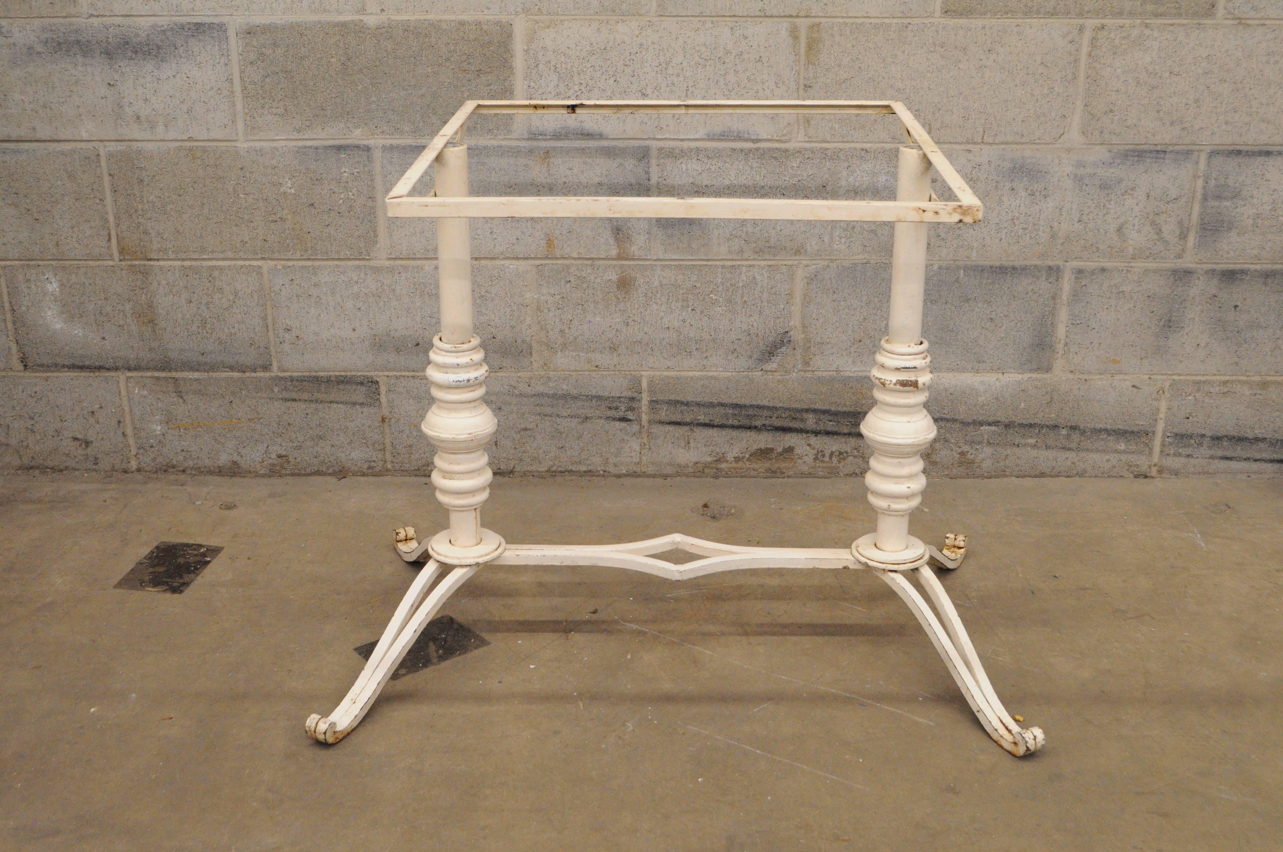 Early to mid-20th century French bistro cast iron pastry table base (no top). Item features a double pedestal base, heavy cast iron frame, scrolling legs, stretcher support, and Classic French form. Great to add a marble or wooden