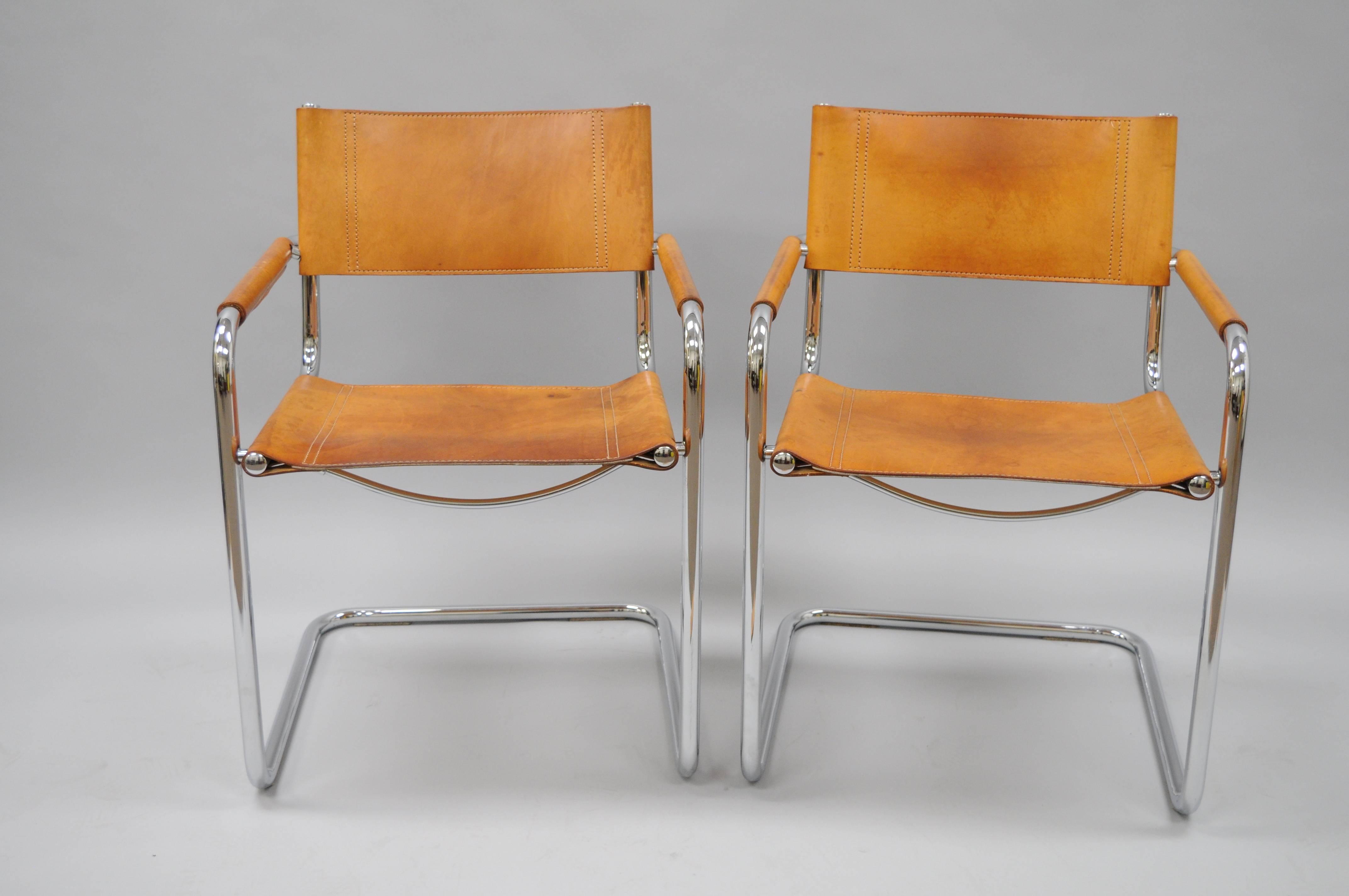 Pair of vintage Mid-Century Italian Modern Cognac Leather S34 Dining Armchairs attributed Mart Stam for Fasem. Chairs feature polished tubular chrome frames, beautiful hand-stitched cognac brown leather with desirable and authentic patina to