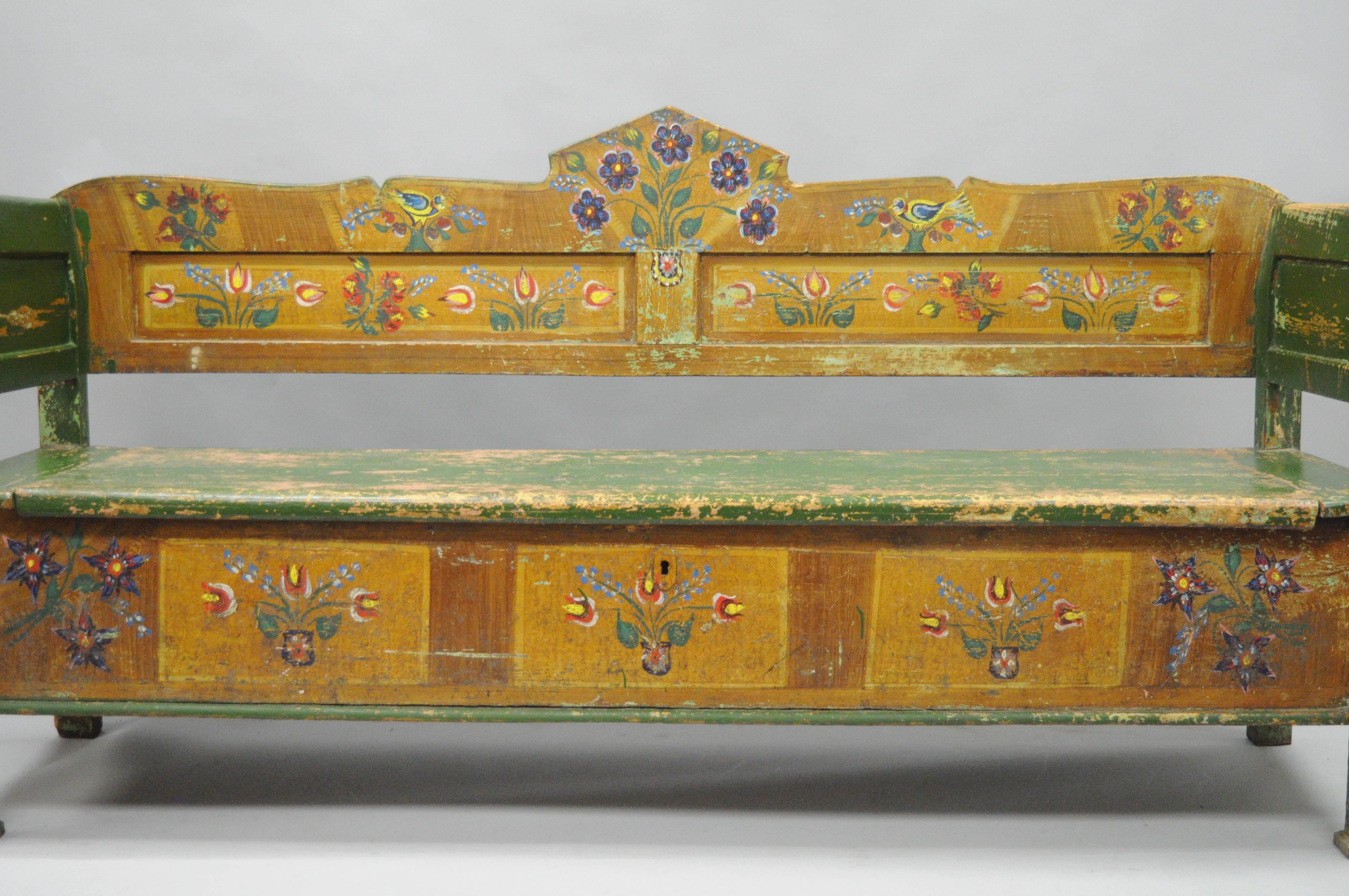 7" foot long antique distress painted green & yellow primitive rustic entry bench with flip seat storage. Item features a weathered green and yellow hand-painted finish with multi colored bird and flower details. Bench further features a