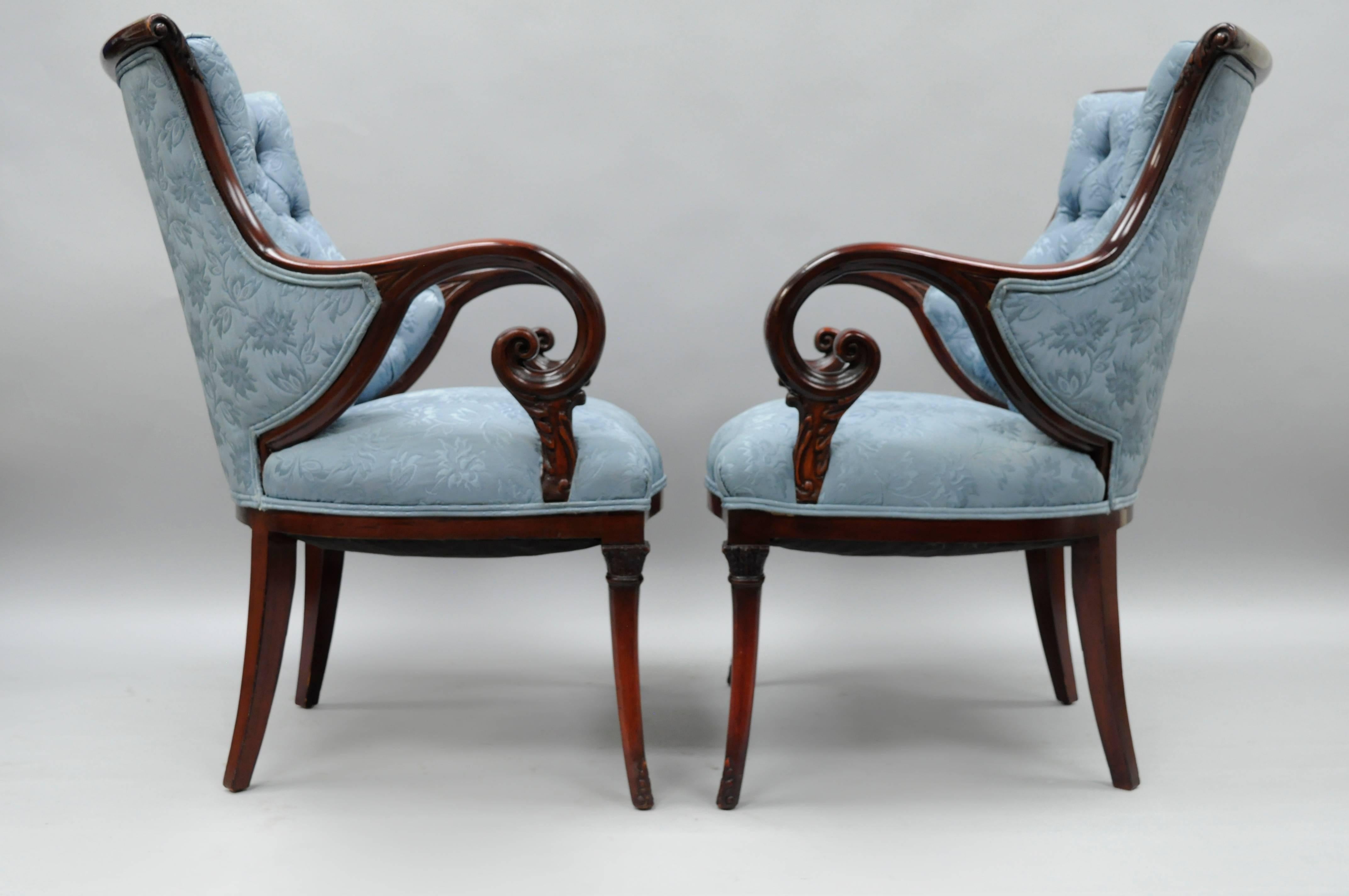Pair of antique Hollywood Regency blue tufted upholstery mahogany frame living room arm chairs with rosewood and brass inlay attributed to Grosfeld House in the Dorothy Draper style. Chairs feature solid carved mahogany wood frames, rosewood inlay