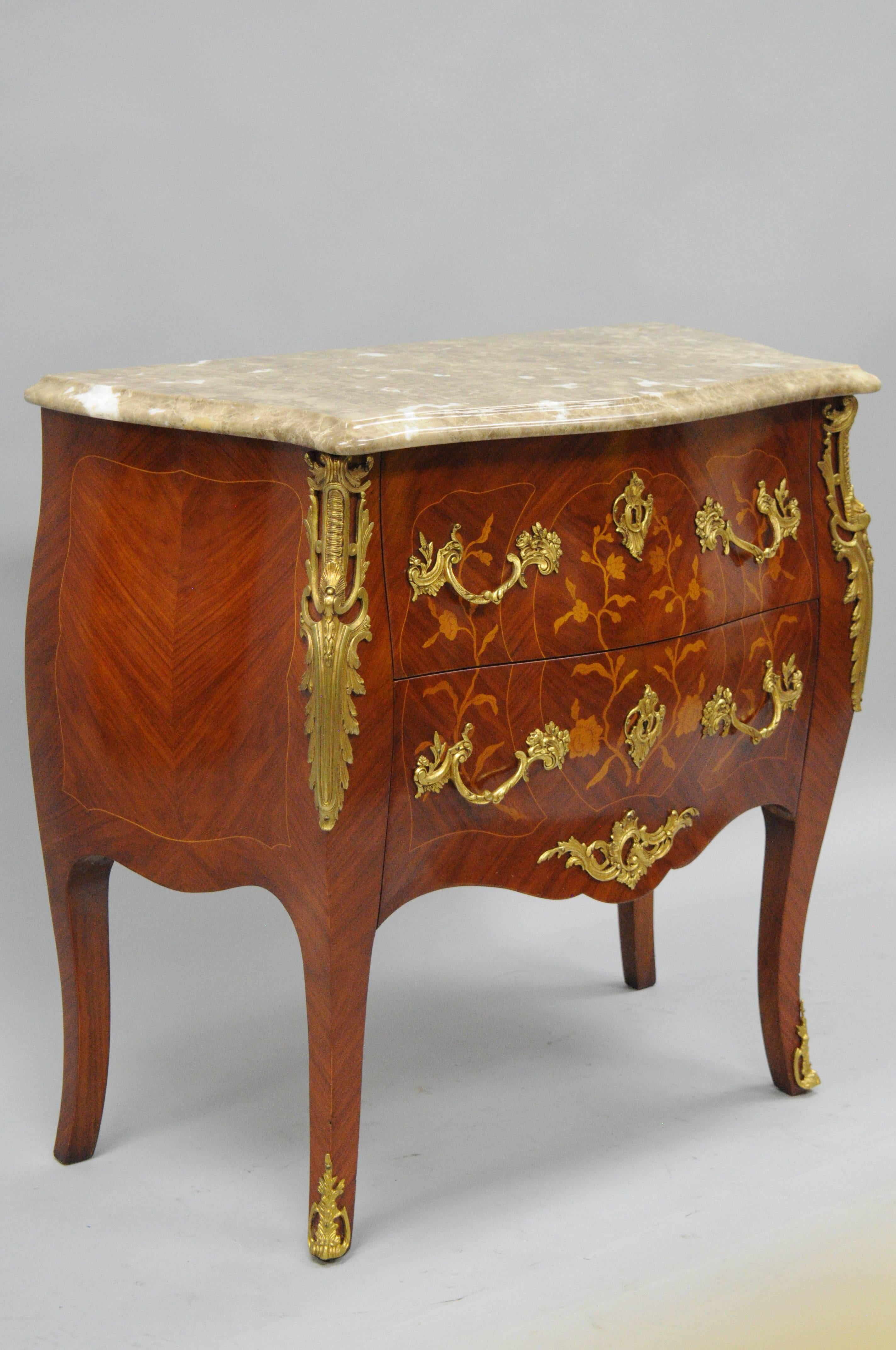 20th century French Louis XV style marble-top bombe form chest / dresser with finely cast bronze ormolu. Item features a shaped tan marble-top with beveled edge, finely cast bronze French Rococo style acanthus ormolu mounts, two drawers (dovetailed
