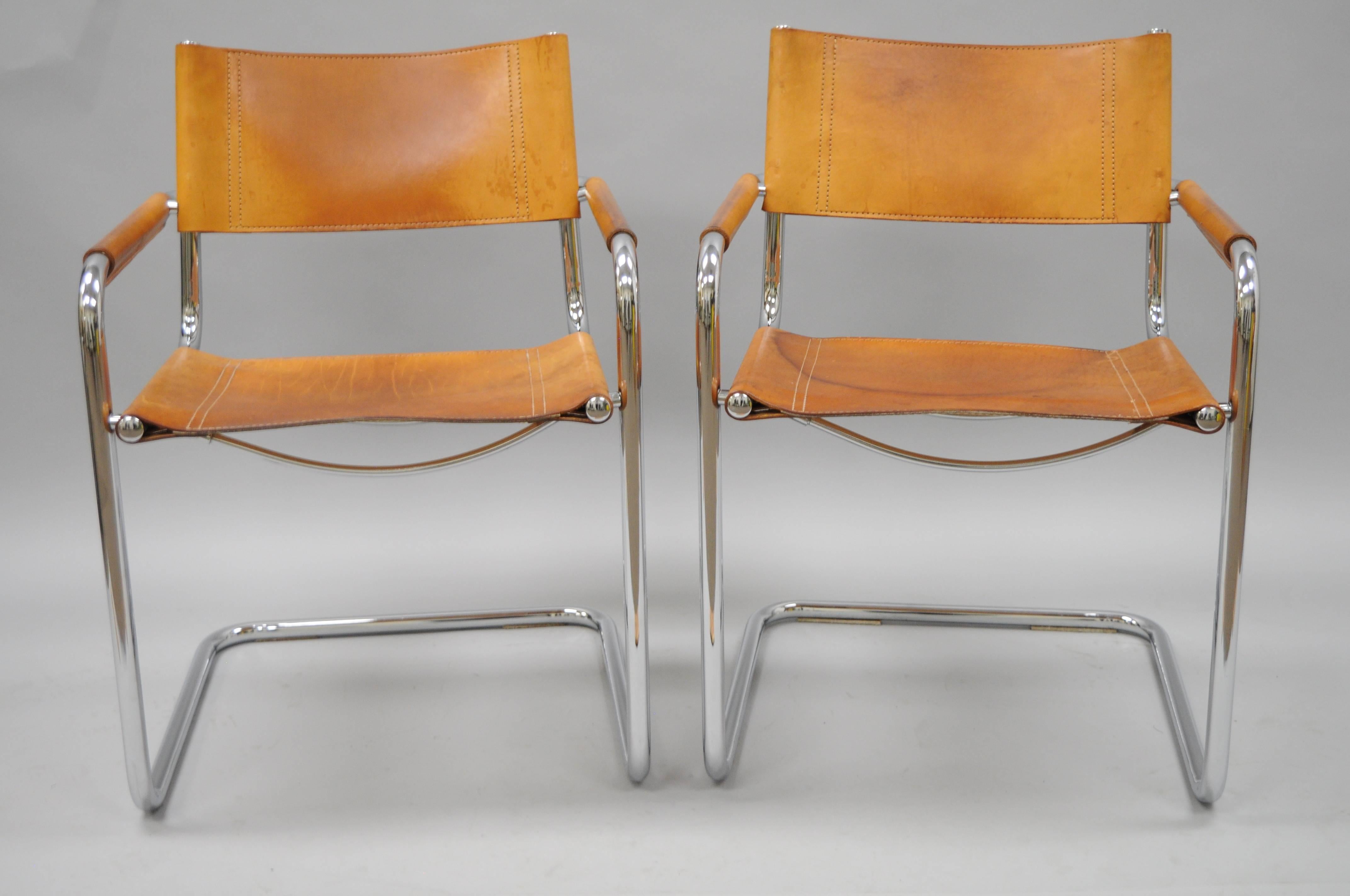 Pair of vintage Mid-Century Italian Modern cognac leather S34 dining armchairs attributed to Mart Stam for Fasem. Chairs feature polished tubular chrome frames, beautiful hand-stitched cognac brown leather with desirable and authentic patina to