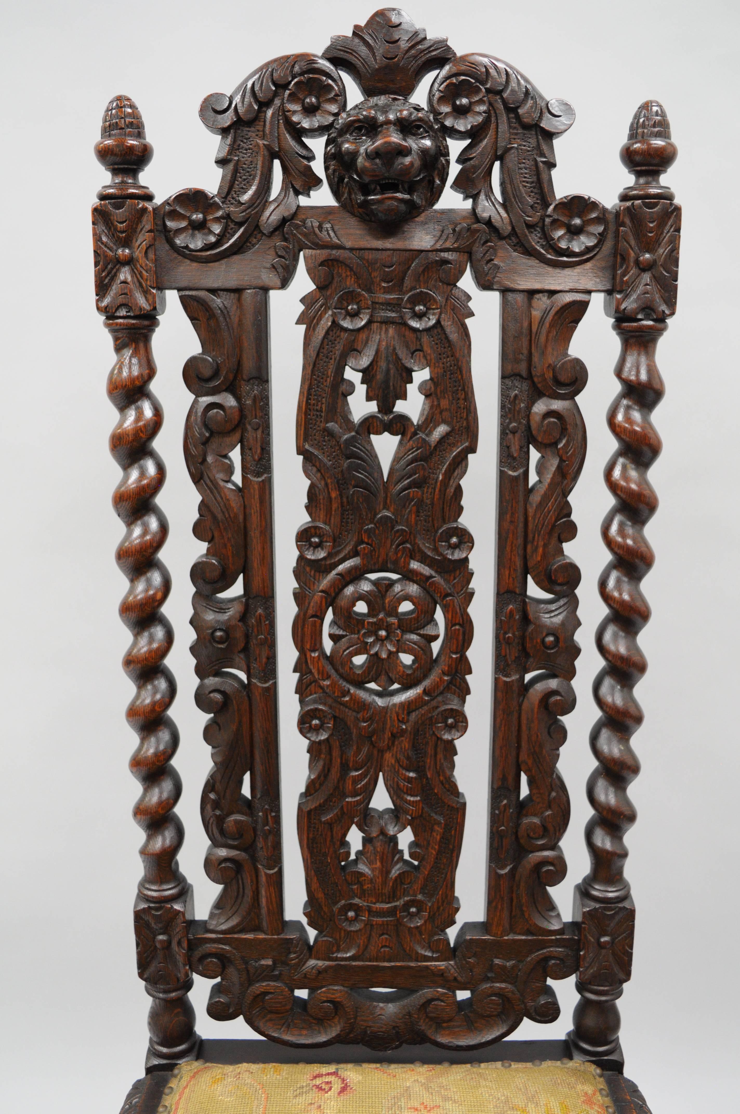 Antique Renaissance Revival figural lion carved oak barley twist high back throne chair. Item features a finely carved solid oakwood frame, including a carved lion head crest, acorn finials, daisy and acanthus leaf carvings, pierce carved barley